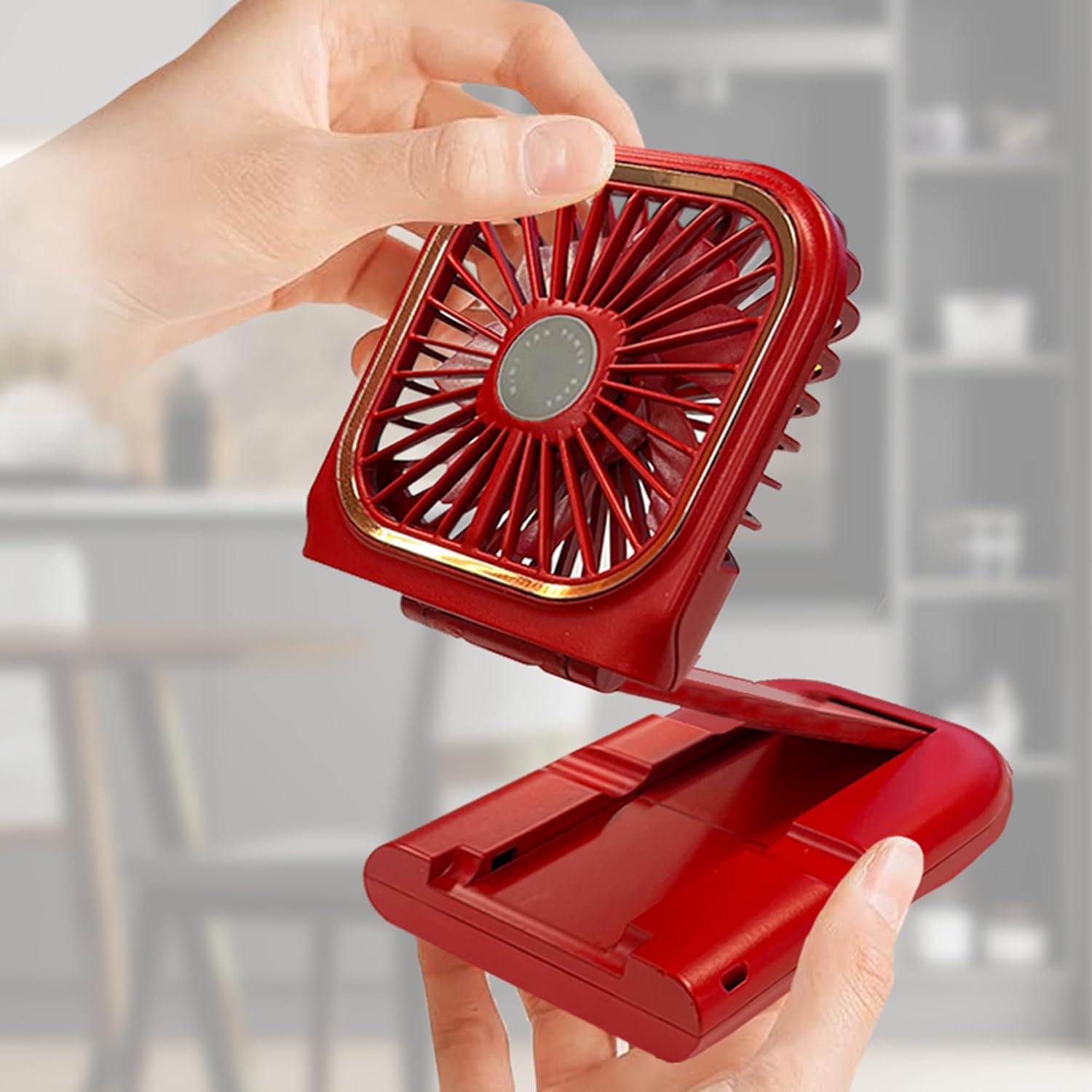 Hands folding and unfolding the Aiwa Neck Fan