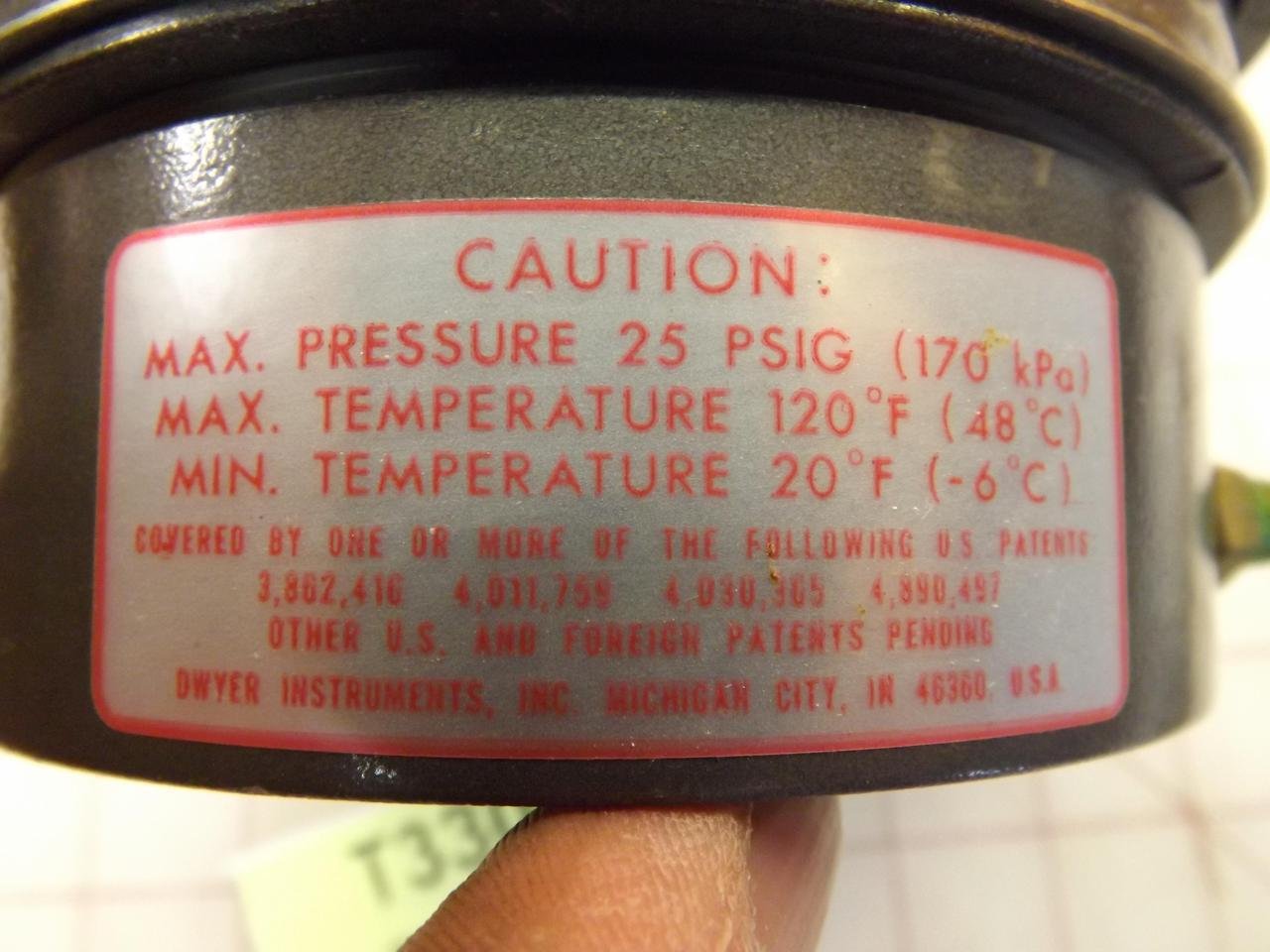 Close-up of the caution label on the Dwyer Magnehelic Series 605