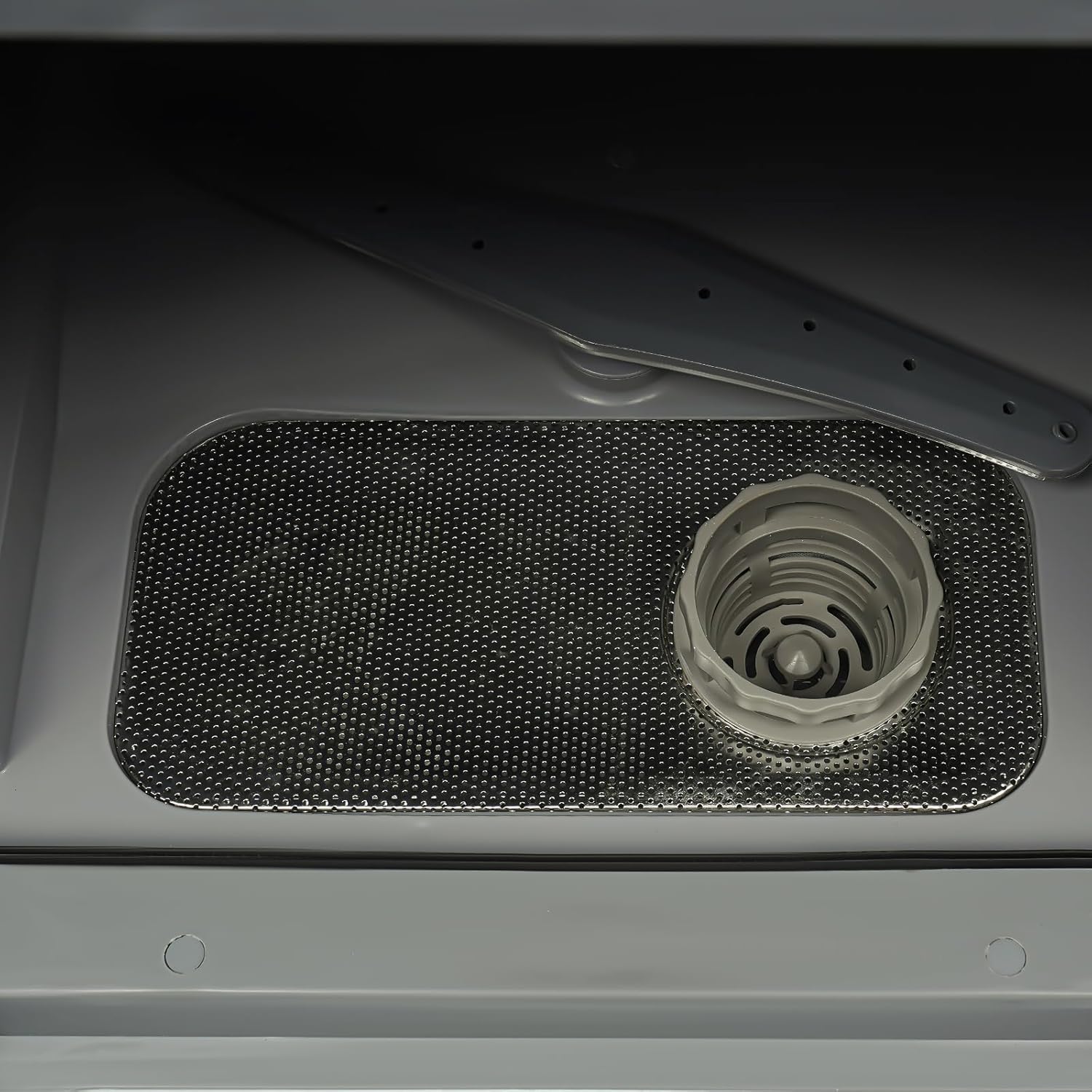 Interior view of the QLK-T18 Mini Countertop Dishwasher, showing the drain filter at the bottom.