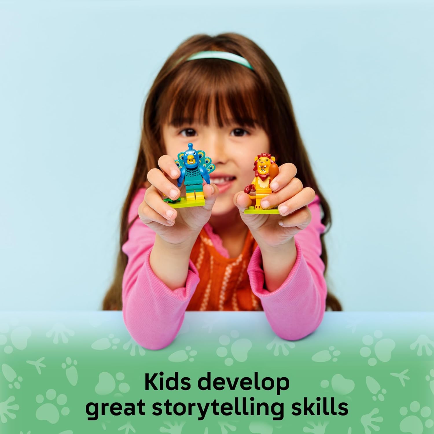A young girl holding two LEGO animal minifigures, a peacock and a lion, encouraging storytelling and imaginative play.