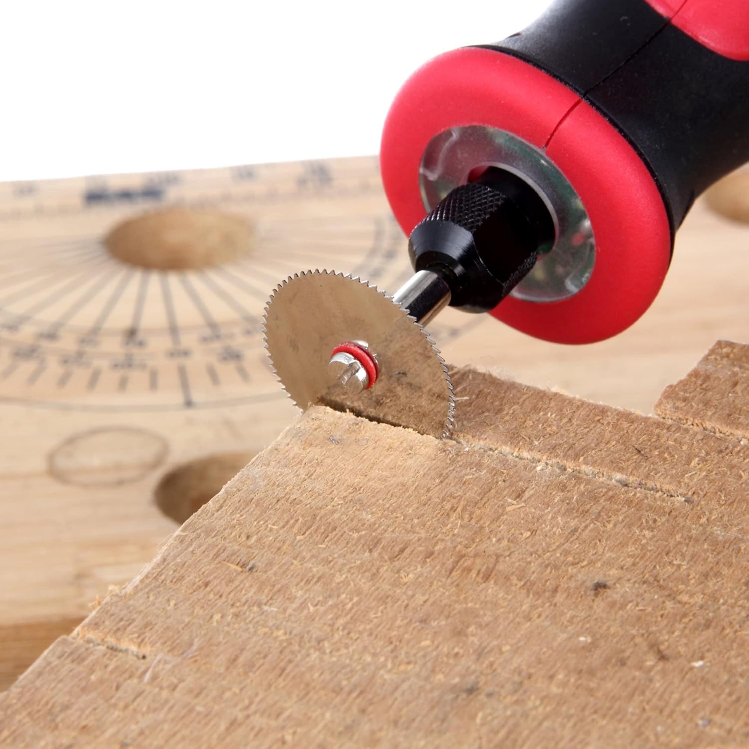 A rotary tool with a steel saw blade cutting into a wooden block.