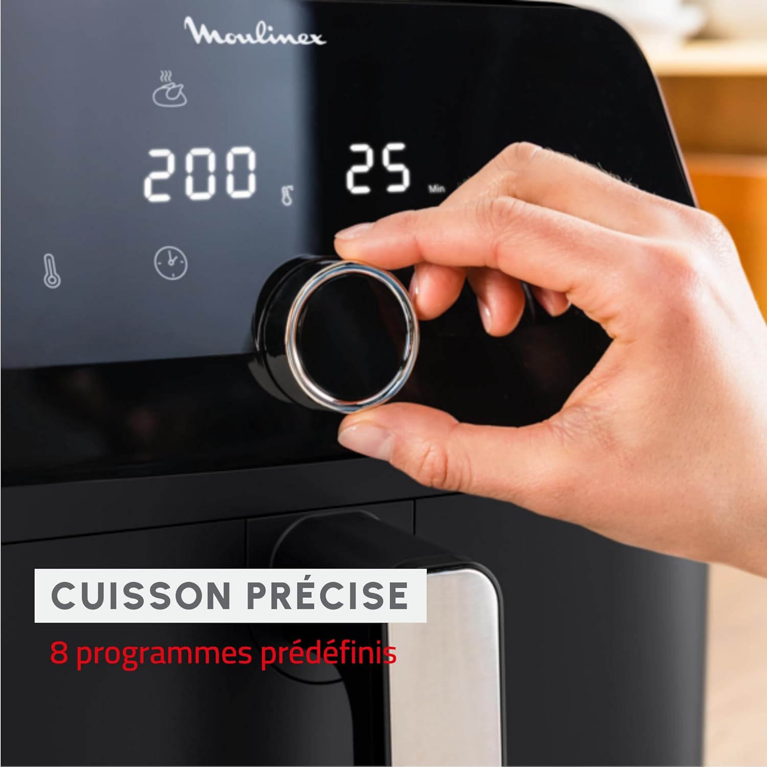 Hand adjusting the rotary dial on the Moulinex Easy Fry Mega Air Fryer