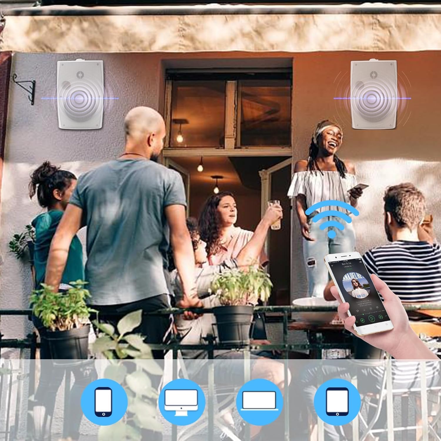 People enjoying music from Herdio speakers installed on a patio, with a smartphone controlling the Bluetooth connection.