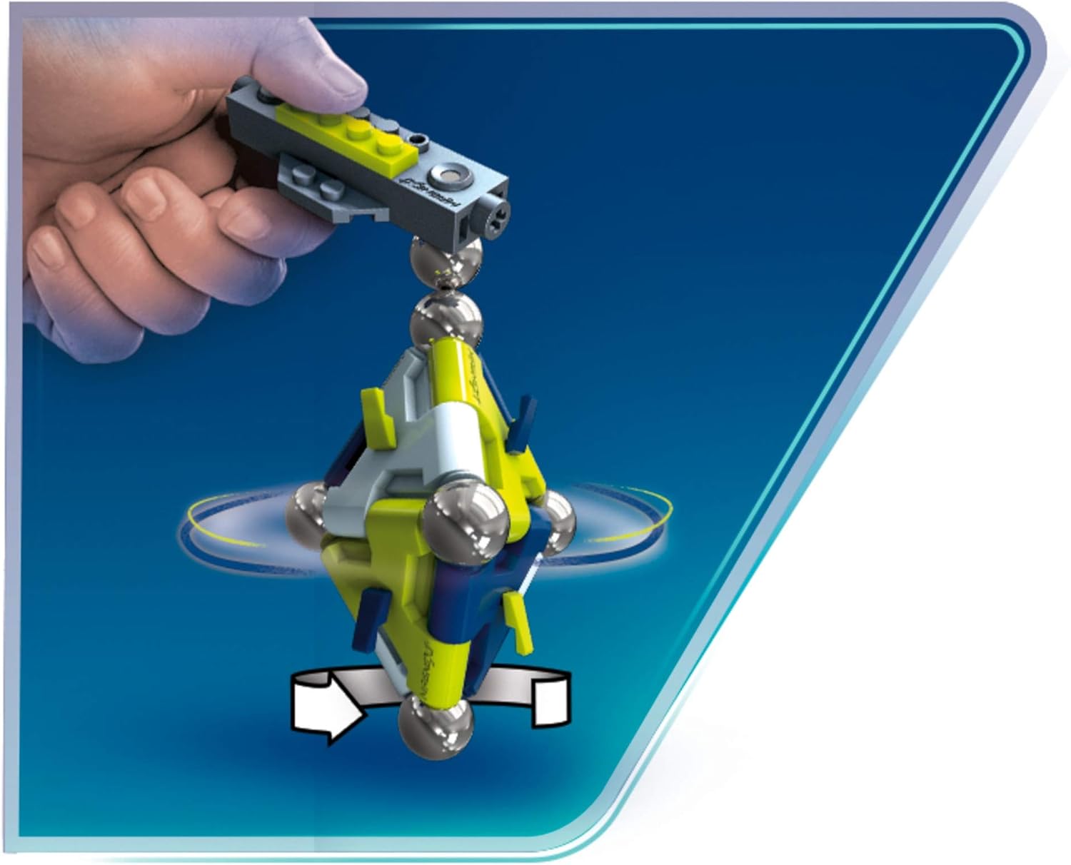 A hand holding the magnetic building brick, suspending and spinning the Magnext Mag-Star.