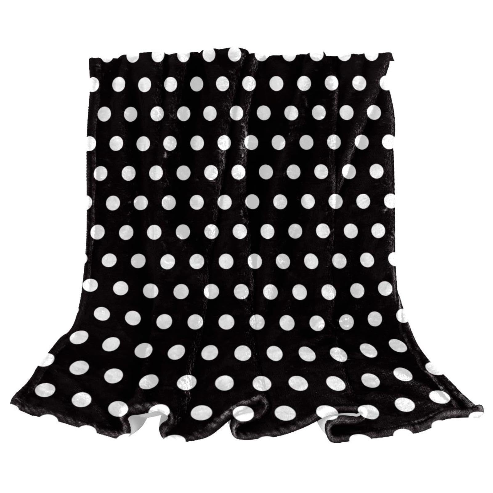 Couverture polaire pois noir et blanc pour ne plus avoir froid sur le canape