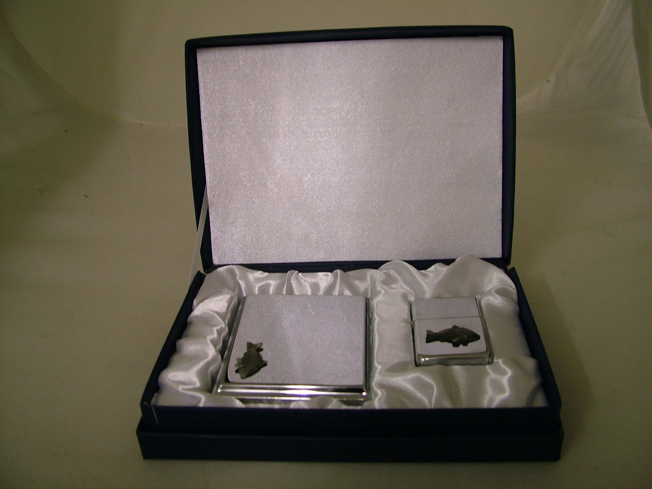 Cigarette case and lighter with carp badge