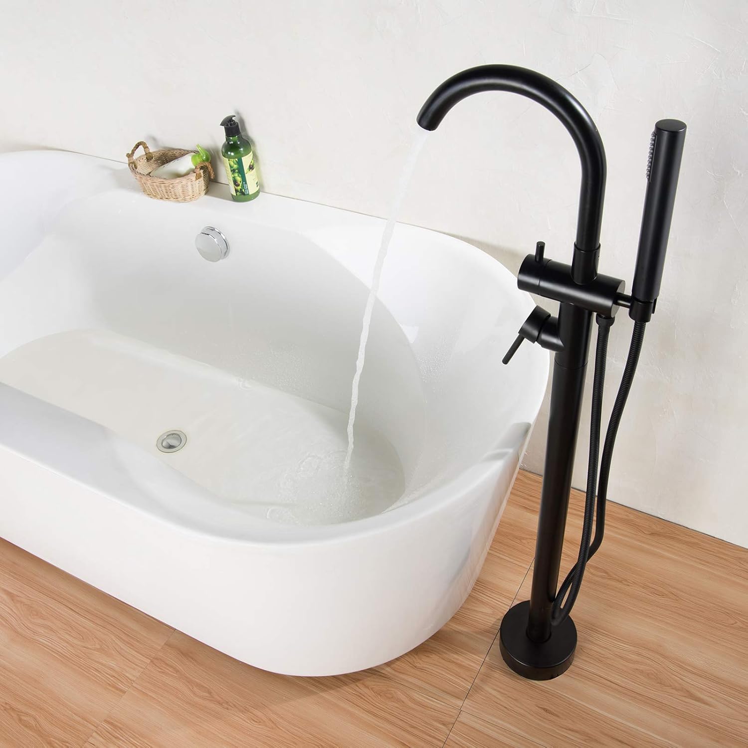Water flowing from the BERNSTEIN 8028B bathtub faucet into a white tub.