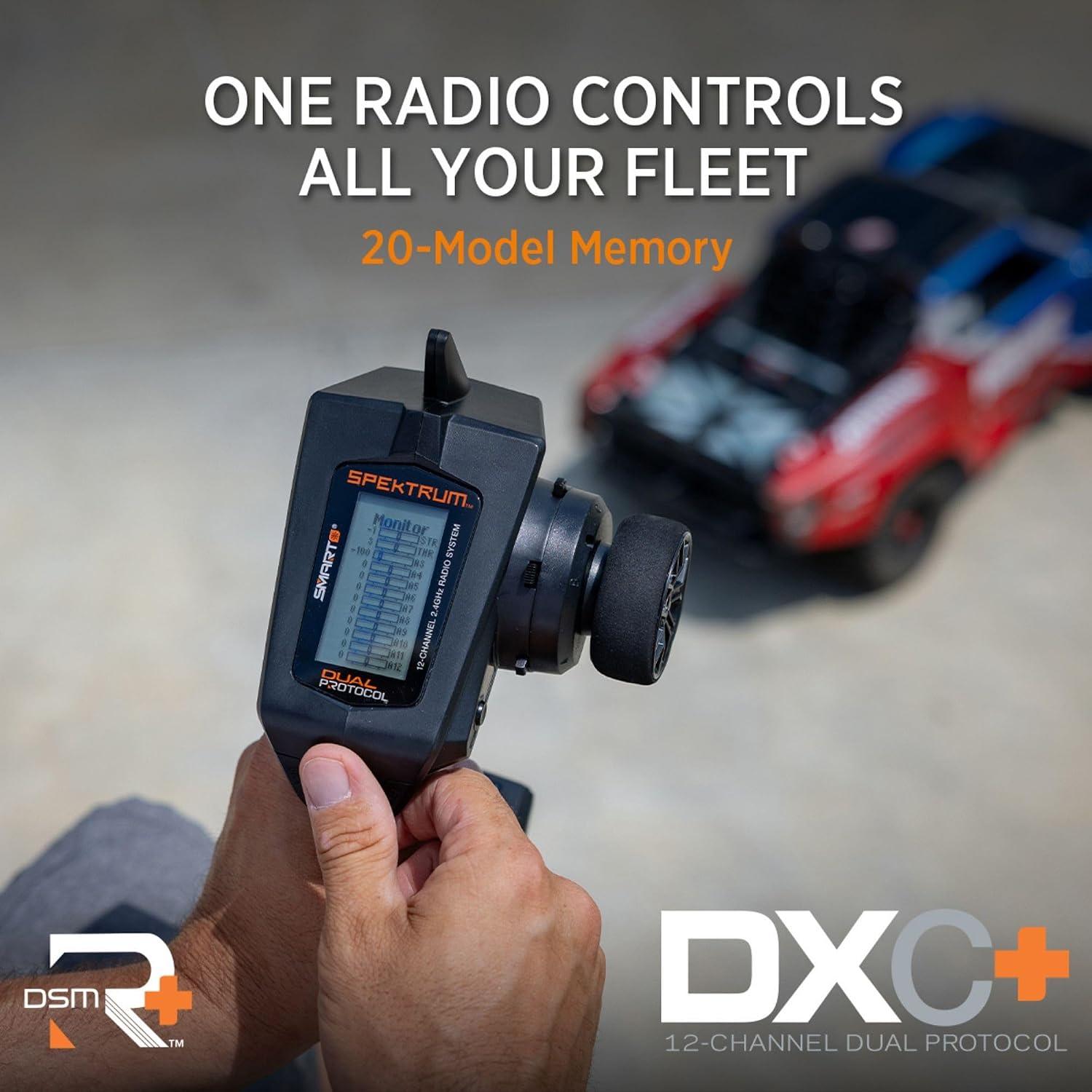 Transmitter held by a hand, highlighting rubber grips and easy-to-reach controls.
