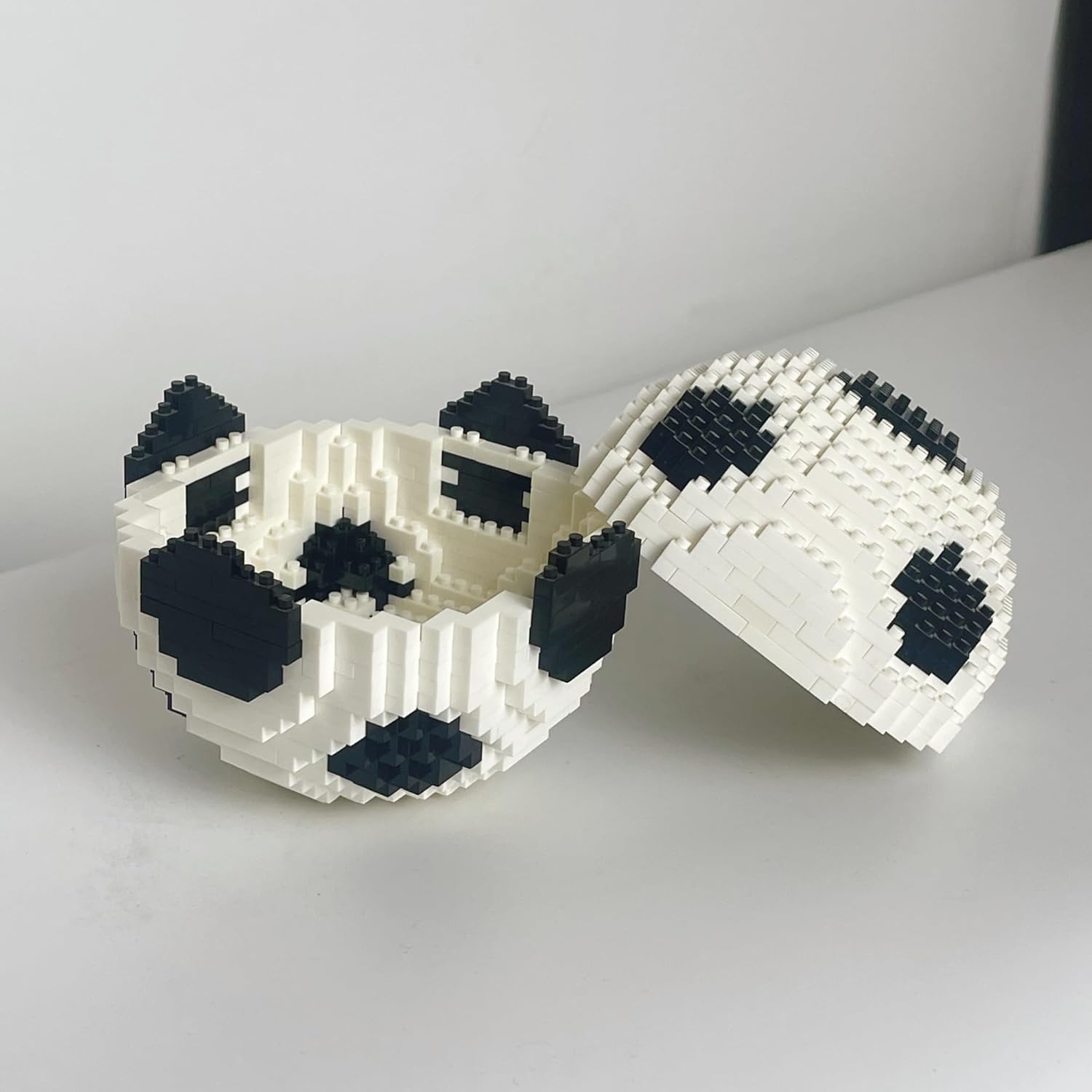 The micro mini building block soccer ball is shown split open into two halves, revealing its hollow interior.