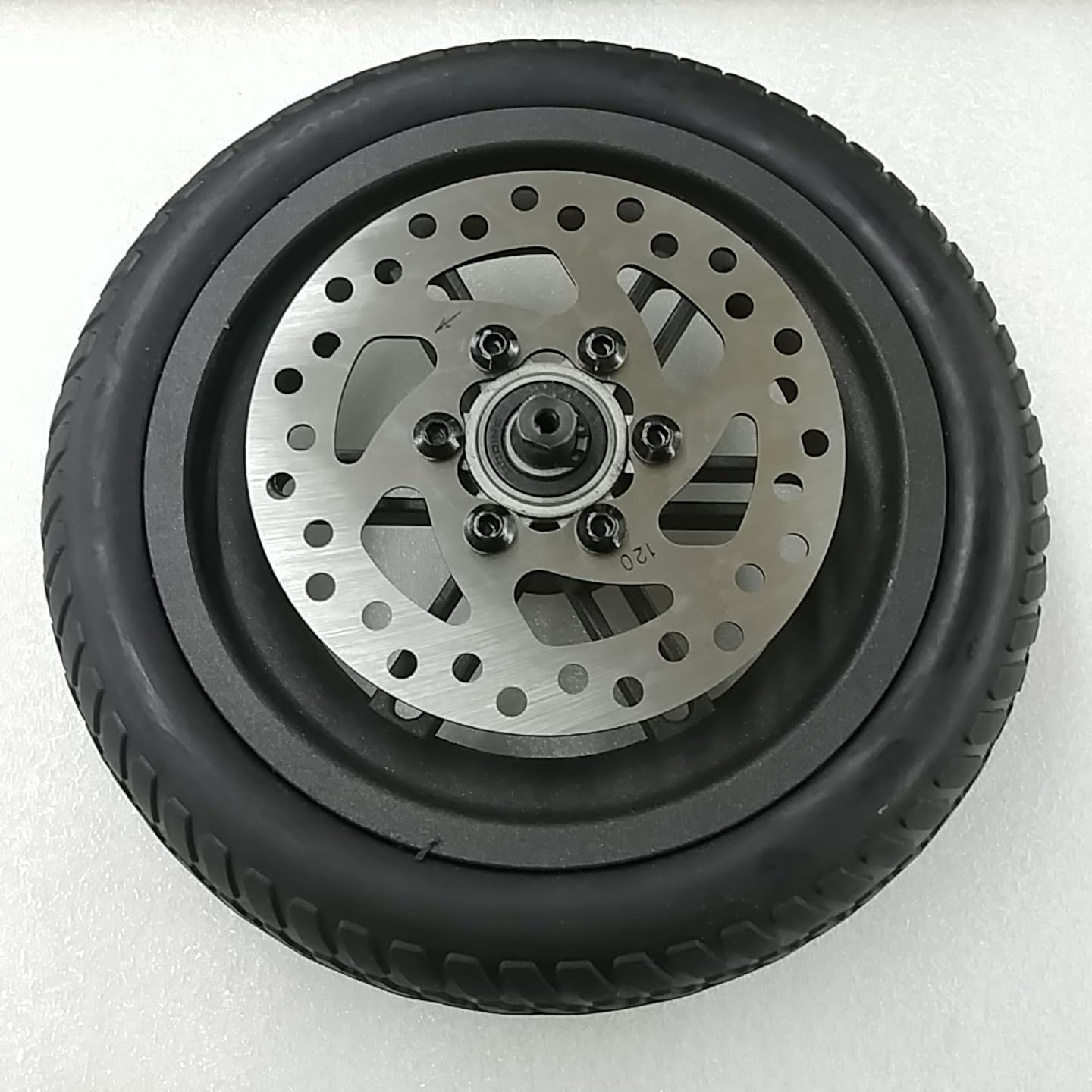 Swagtron Swagger 8.5-inch rear wheel replacement with solid rubber tire and 120mm brake rotor, viewed from the side showing the rotor.