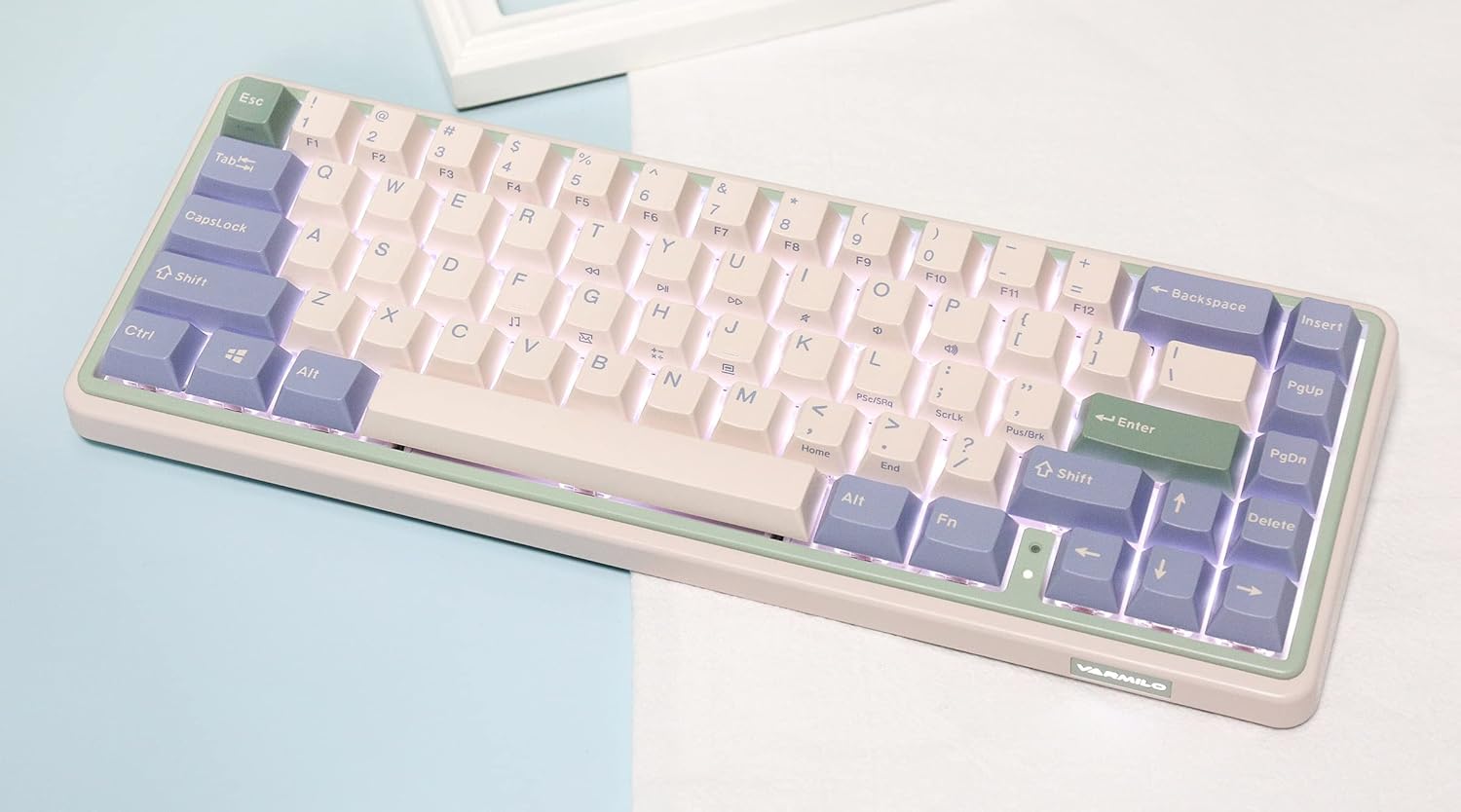 Abgewinkelt view of the Varmilo Minilo VXB67 keyboard with white LED backlighting active.