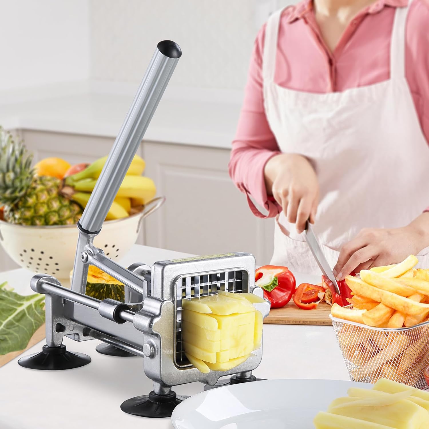 Person using the VEVOR LD03 French Fry Cutter to cut potatoes, with other vegetables and cut fries visible