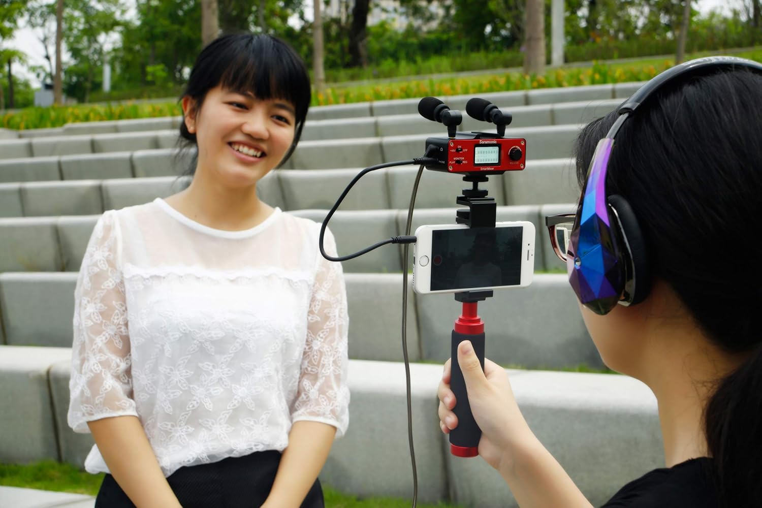 Two individuals using the Saramonic SmartMixer rig for an interview