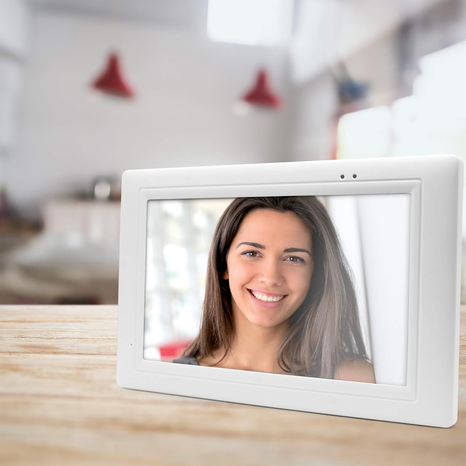 Thomson Wireless Video Doorphone indoor monitor unit resting on a wooden table.