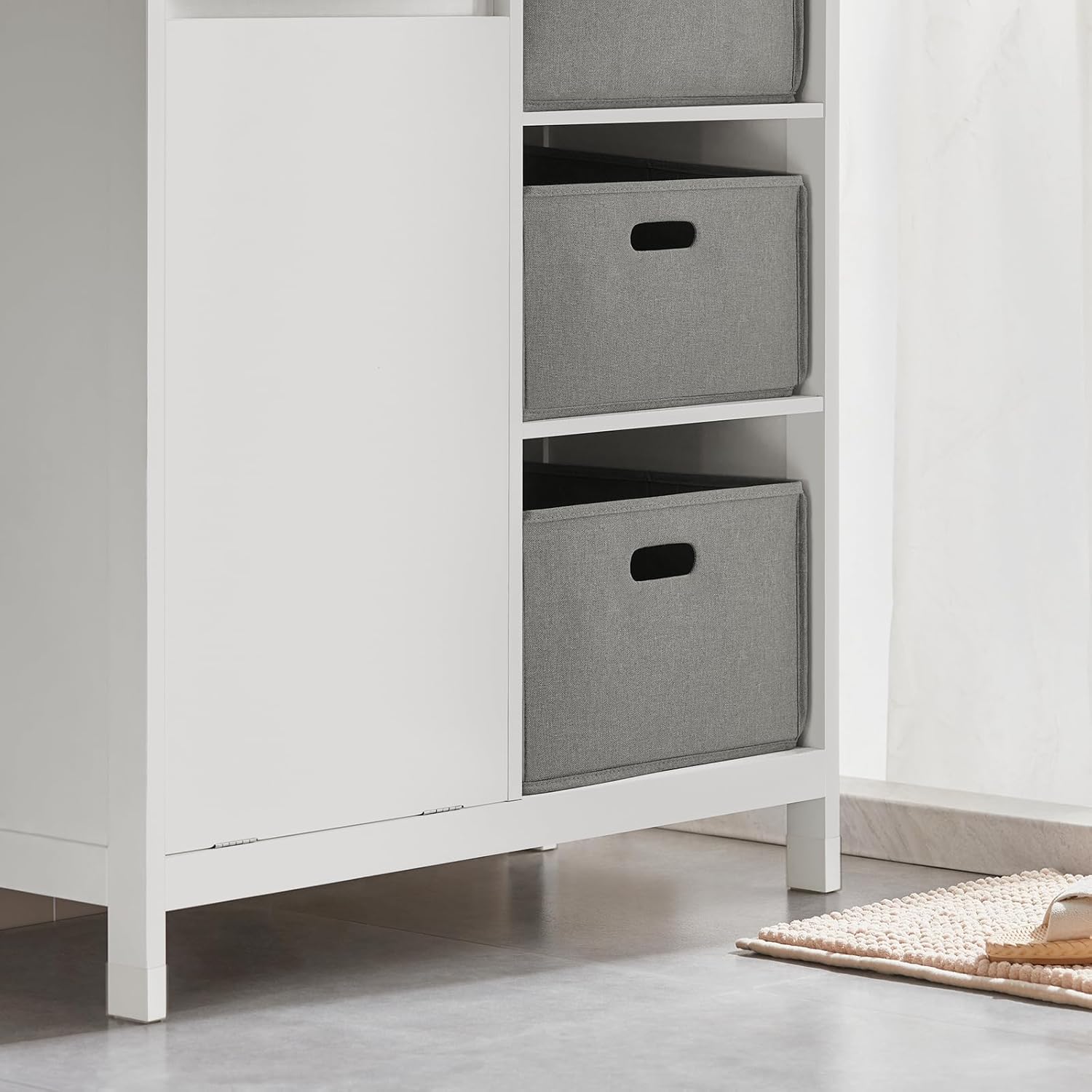 Hand opening the tilt-out laundry basket door of SoBuy BZR77-W