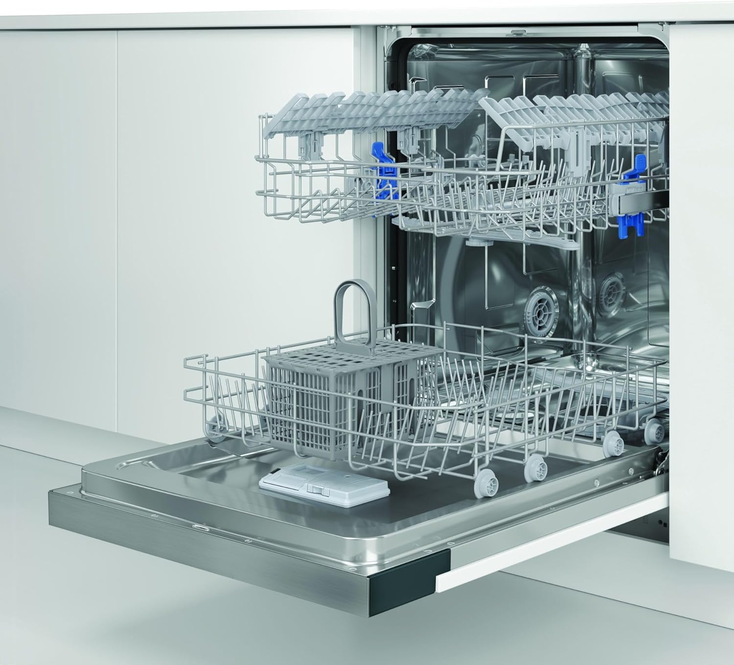 Interior view of the Indesit dishwasher showing empty upper and lower racks and a cutlery basket.