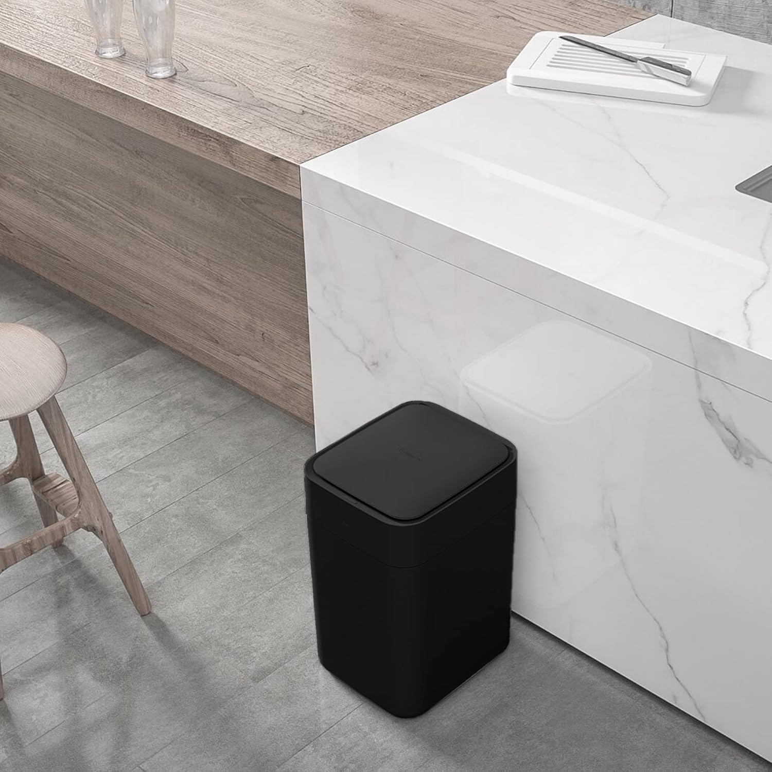 TOWNEW T1S Smart Trash Can in a kitchen setting, with a sealed trash bag next to it, illustrating the self-sealing and self-changing process.