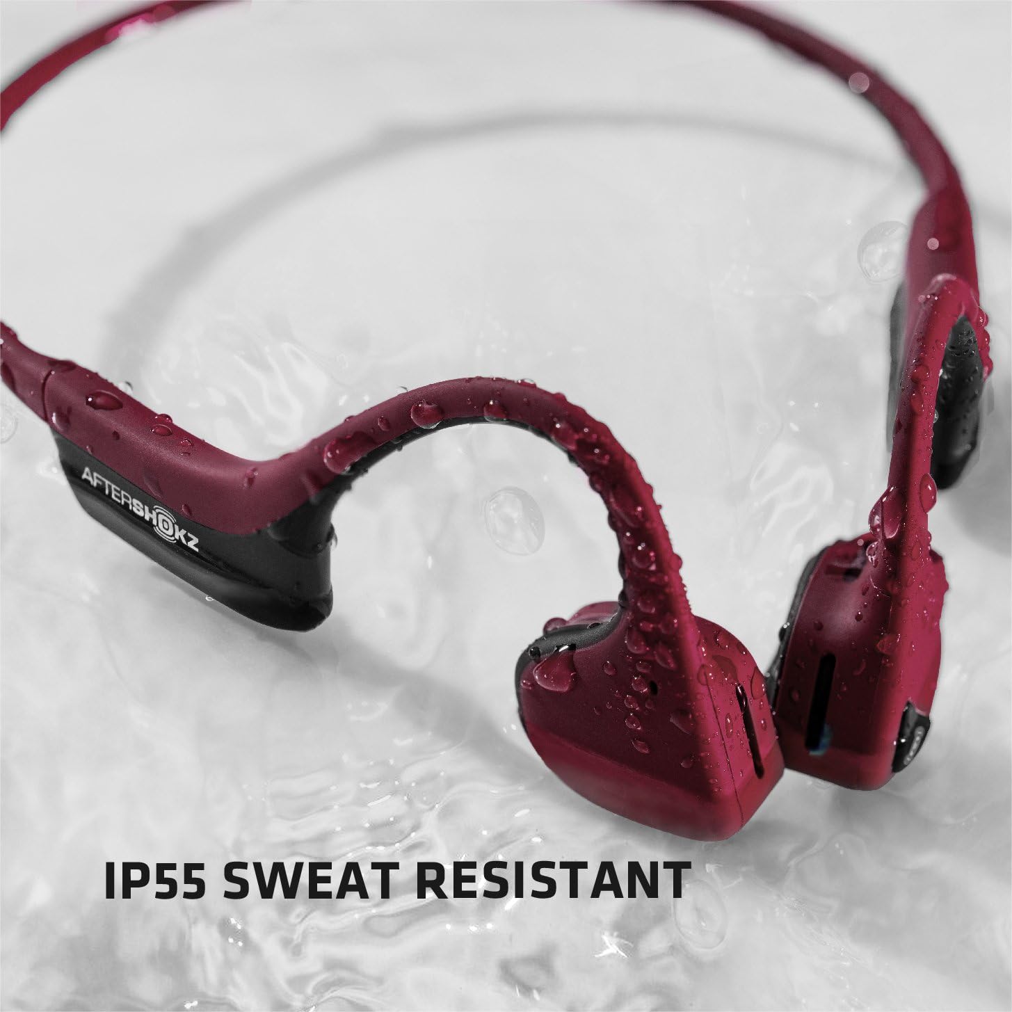 AfterShokz Air headphones with water droplets, illustrating IP55 sweat resistance.