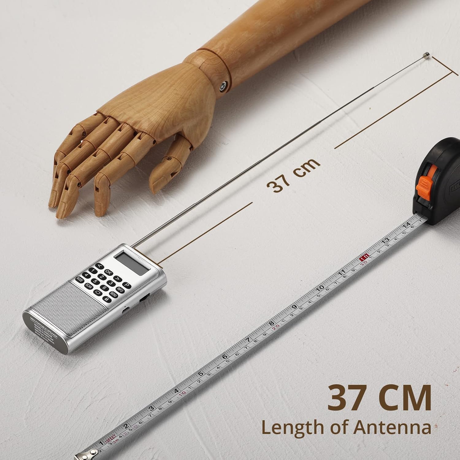 Raddy RD23 radio with fully extended antenna next to a measuring tape
