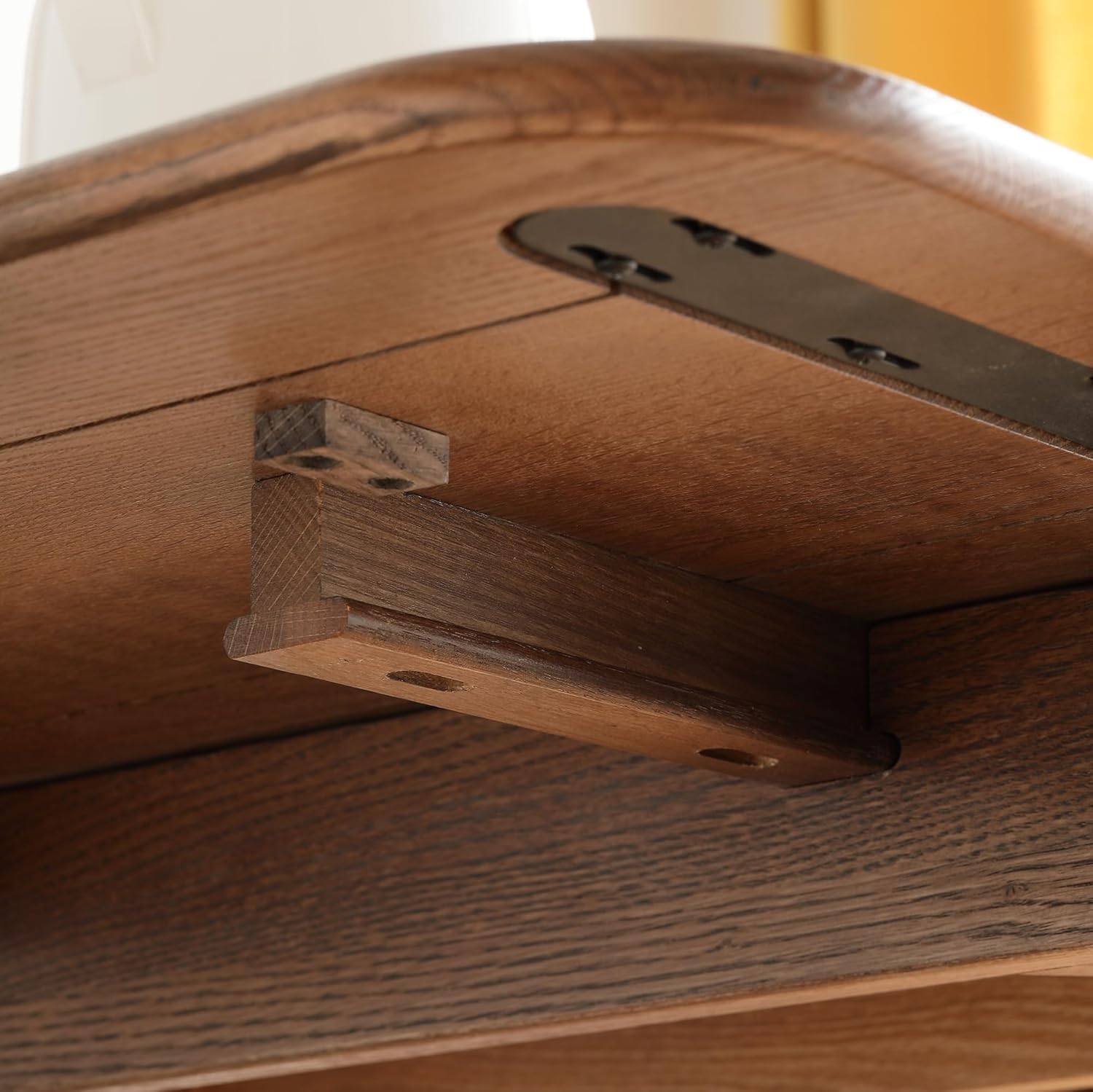 Close-up of a wooden support bracket underneath the table, providing stability for the extension.