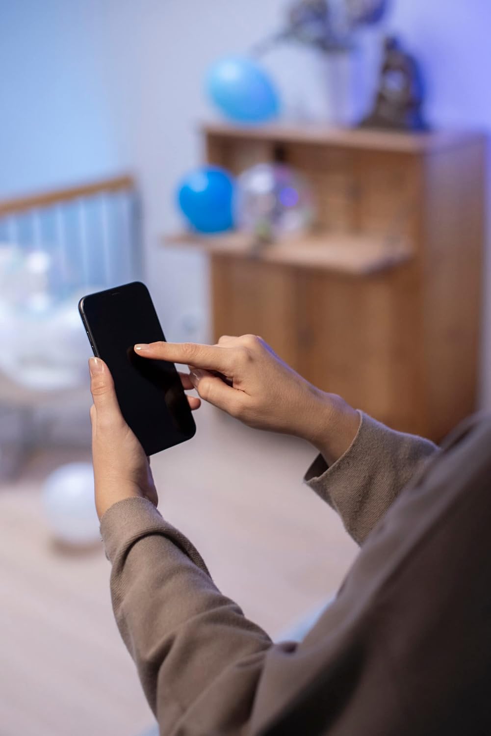 Close-up of a hand interacting with the Airam SmartHome app interface on a smartphone.