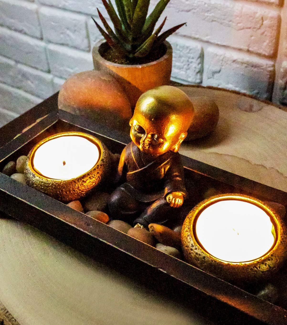 Ebros Meditating Baby Buddha Monk Shakyamuni by Twin Gold Barrels Tea Light Votive Candle Holder with Rock Pebbles Zen Garden Figurine Buddhism Amitabha Candleholder Zen Home