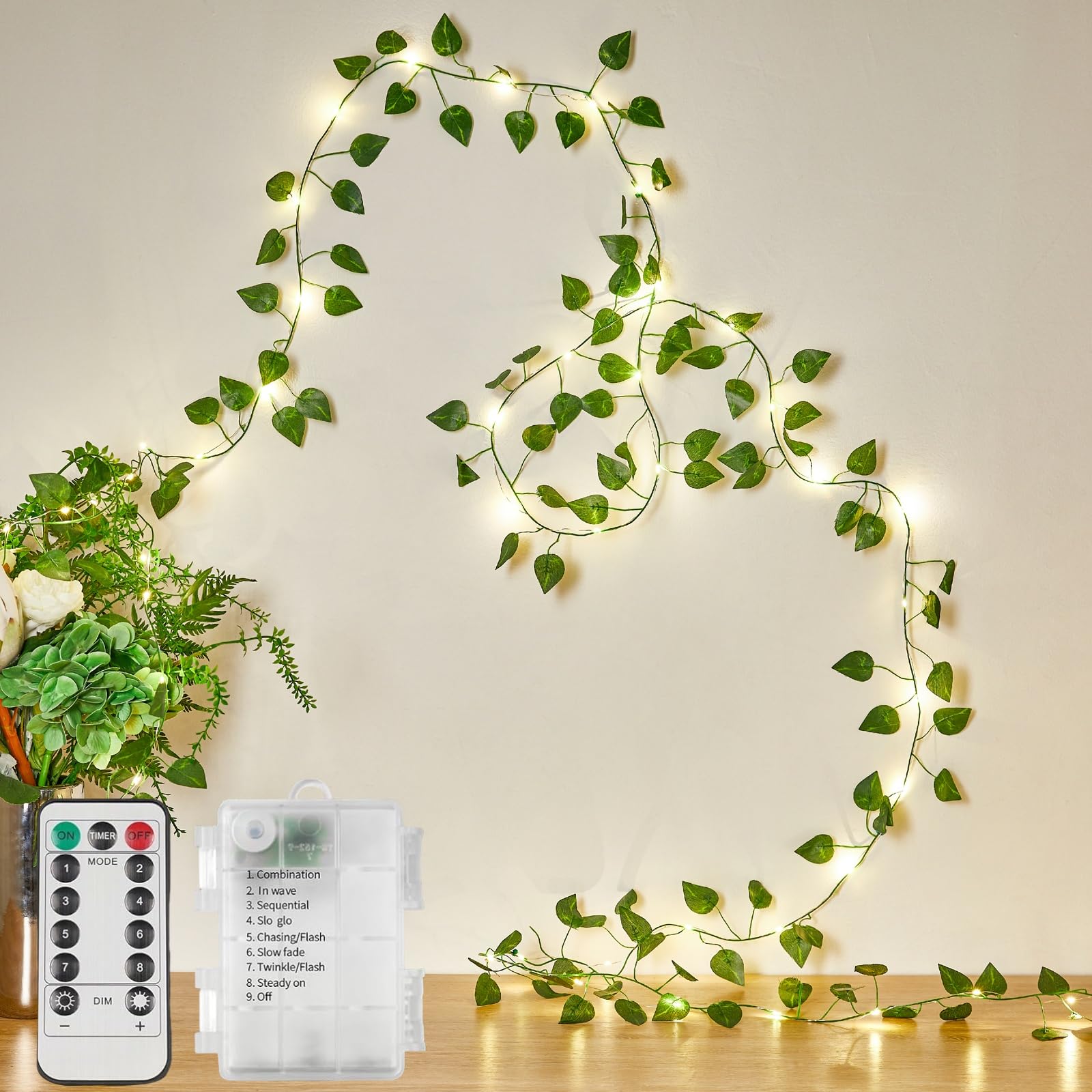 KAiSnova 33FT 100LED Vine with Fairy Lights Battery Operated, Warm White Pothos String Lights with Remote, Simulated Leaf Lights for Room Garden Party