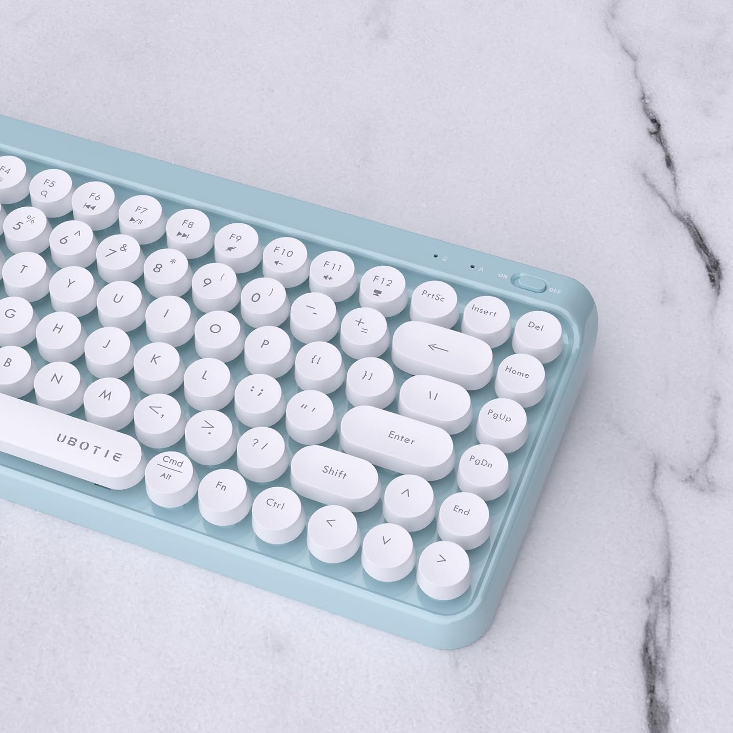 Close-up image of the UBOTIE keyboard's top right corner, showing the power switch and indicator lights.