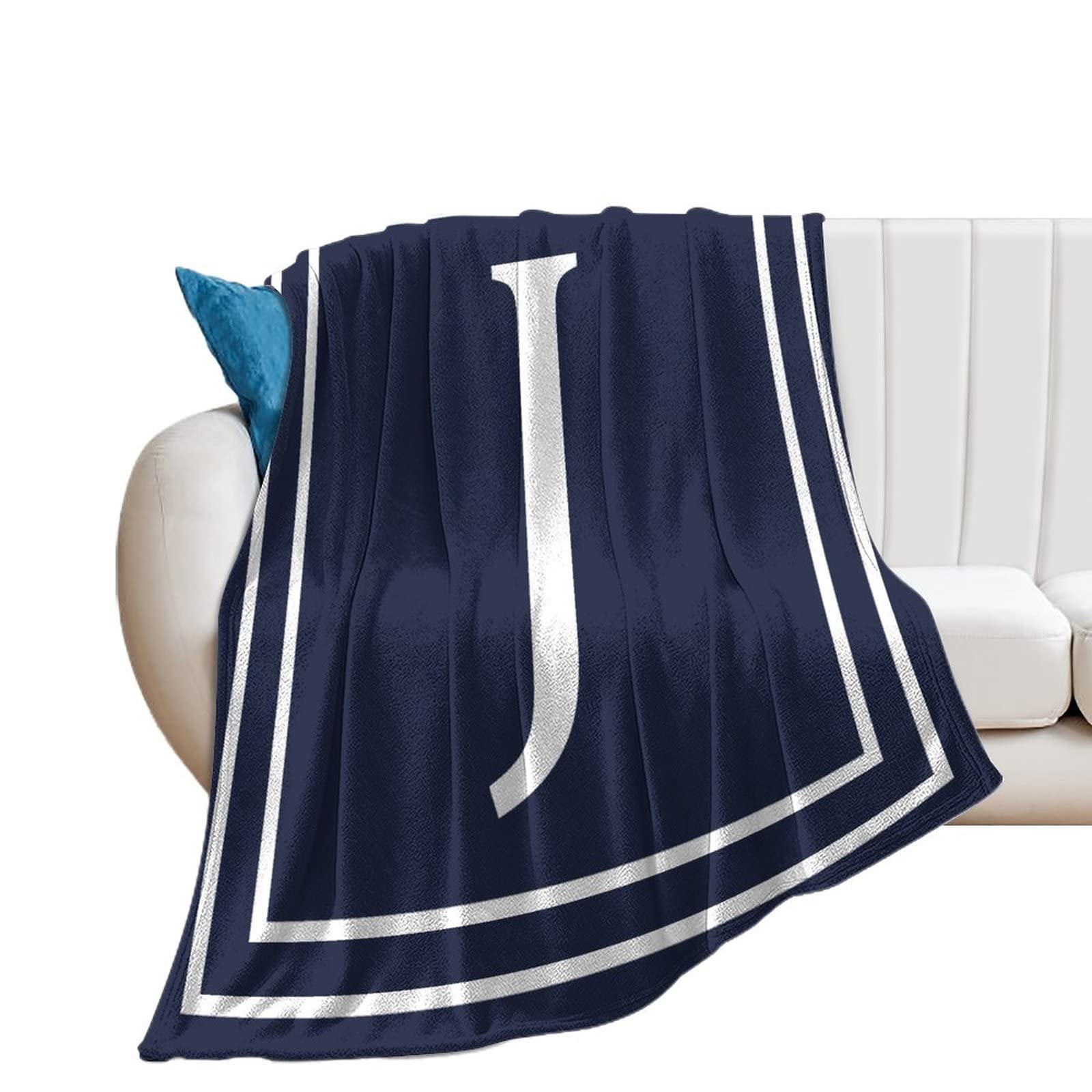 Couverture bleu marine initiale J en flanelle contre le froid sur le canapé ou le lit