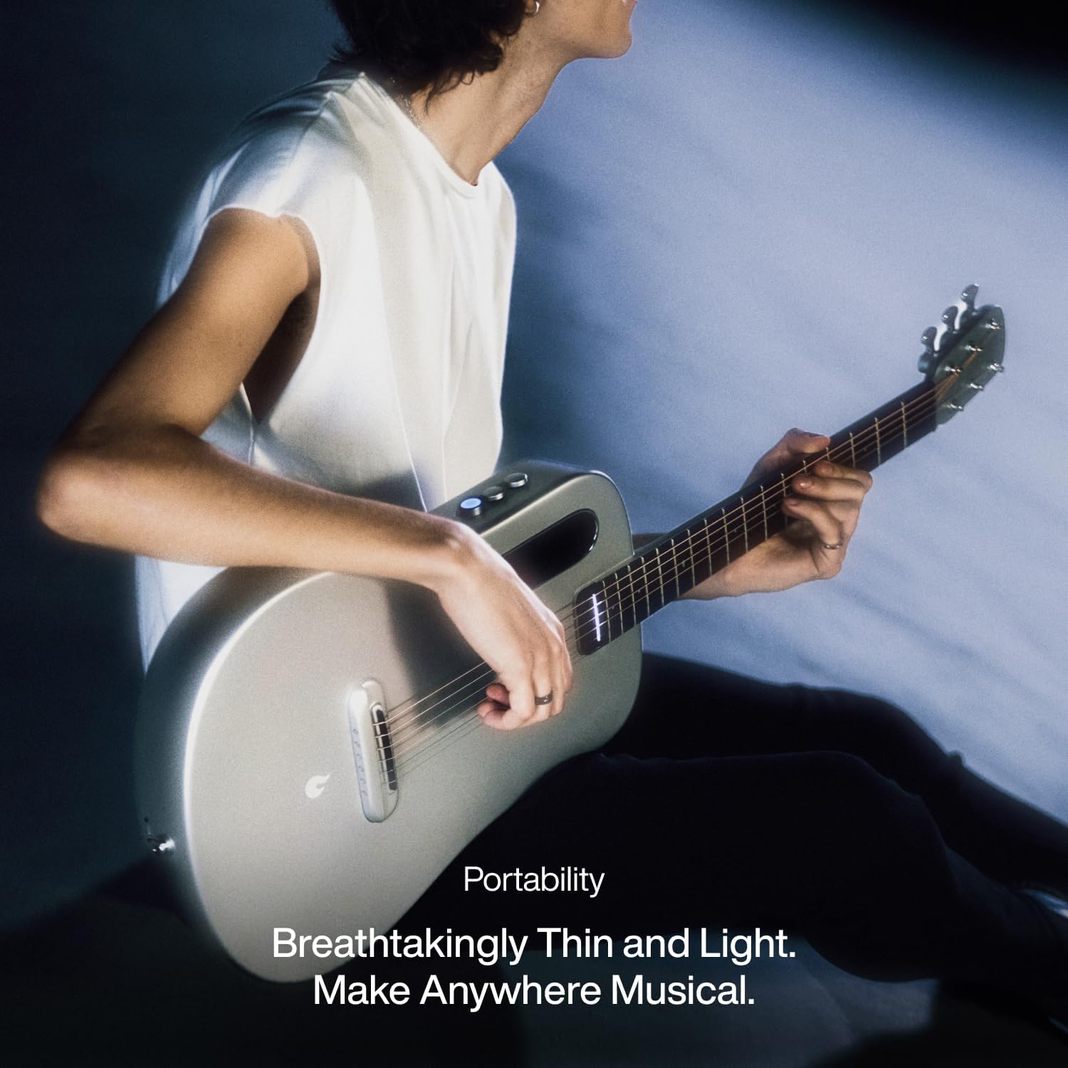 Person playing the LAVA ME AIR guitar, highlighting its thin and light design.