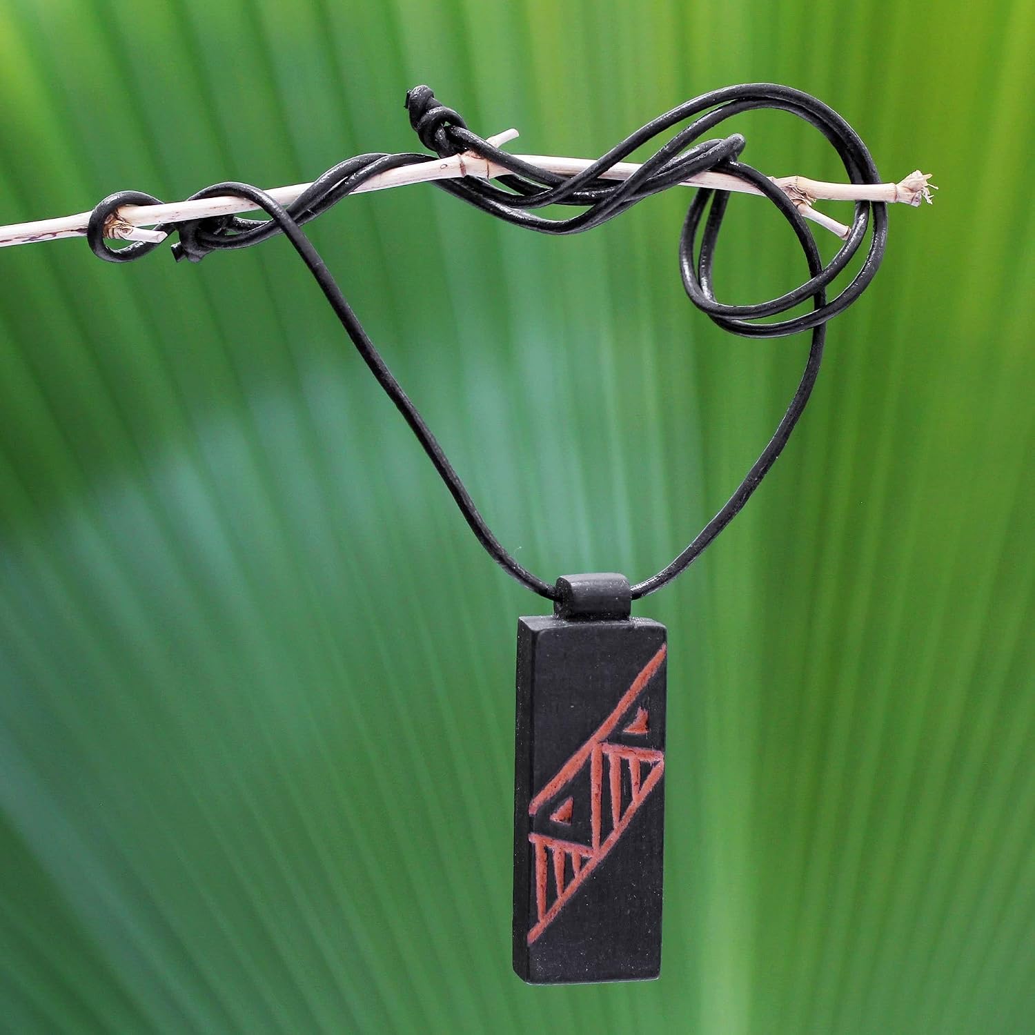 NOVICA Artisan Handmade Men's Teak Wood Pendant Necklace Leather Cord Ghana [26 in min L x 32 in max L 3 mm W Pendant(s) 3.1 in L x 2 in W] ' Kente Man'