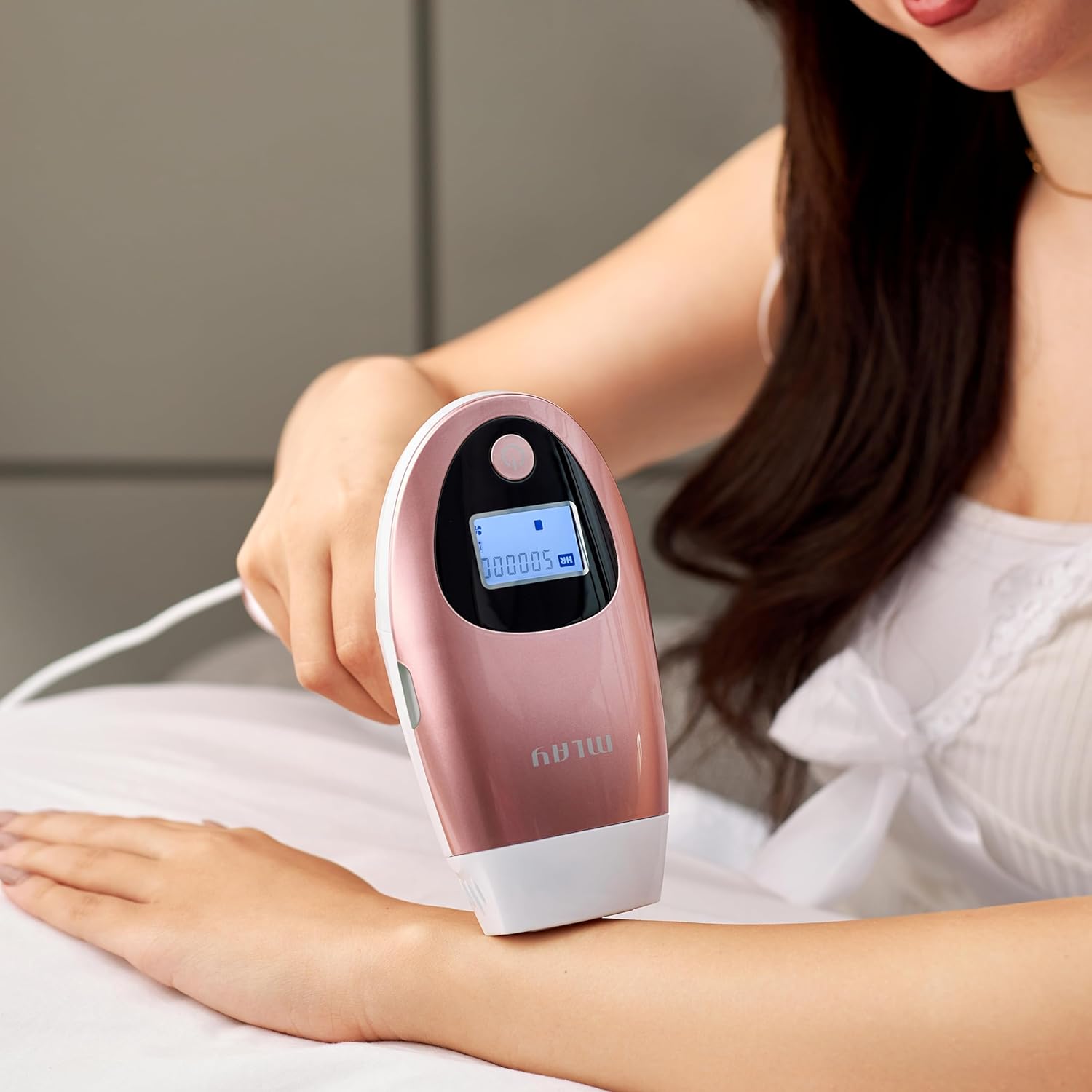 Person using MLAY T3 IPL device on their arm