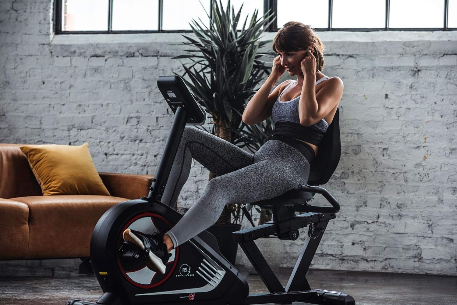 Woman exercising on the Christopeit Sport RS 3 Recumbent Ergometer in a home setting