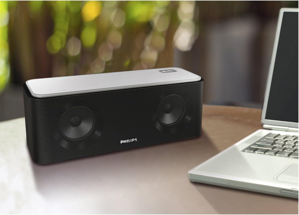 Philips SB365B/37 speaker placed on a table next to a laptop