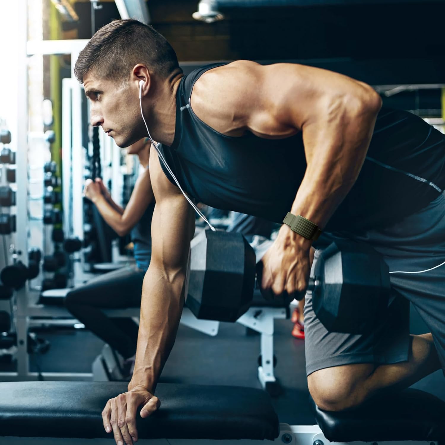 Man lifting weights while wearing the Whoop band