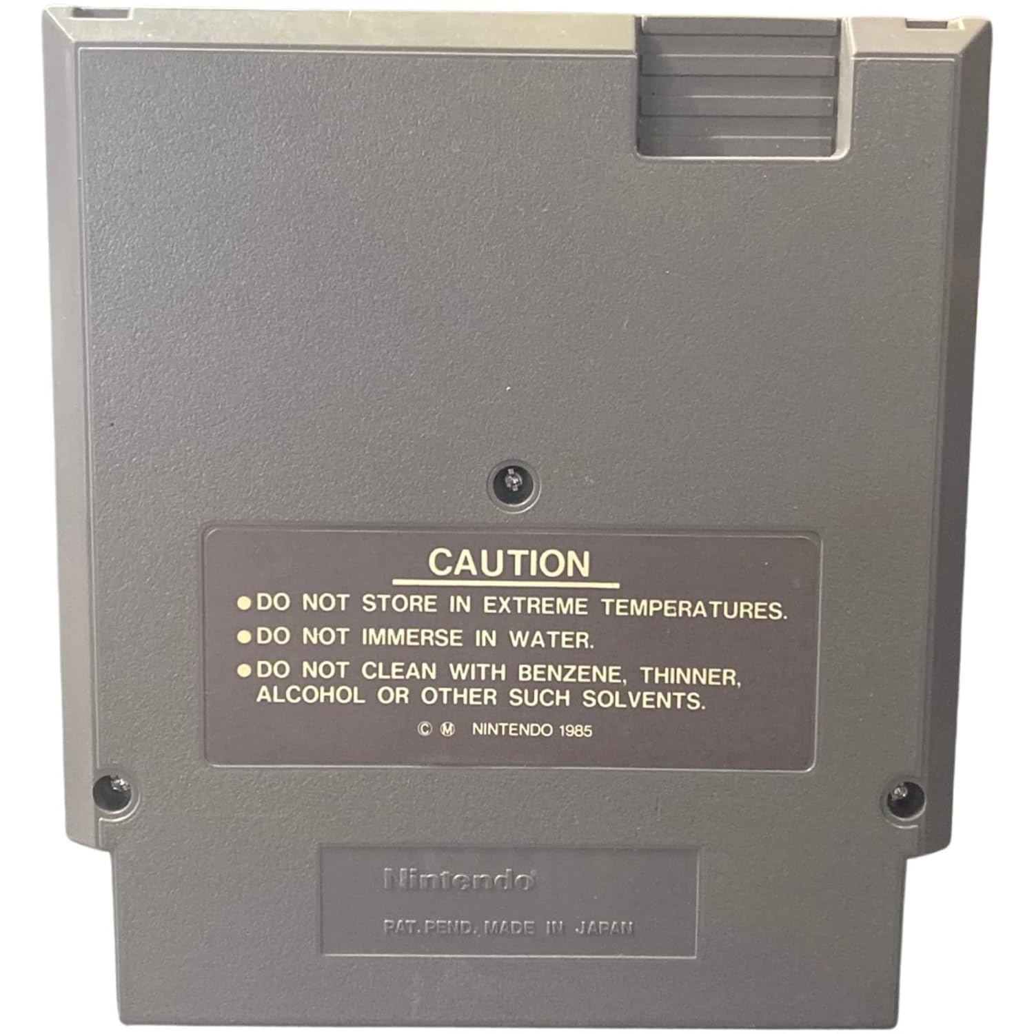 Back of Mega Man NES game cartridge with a caution label.