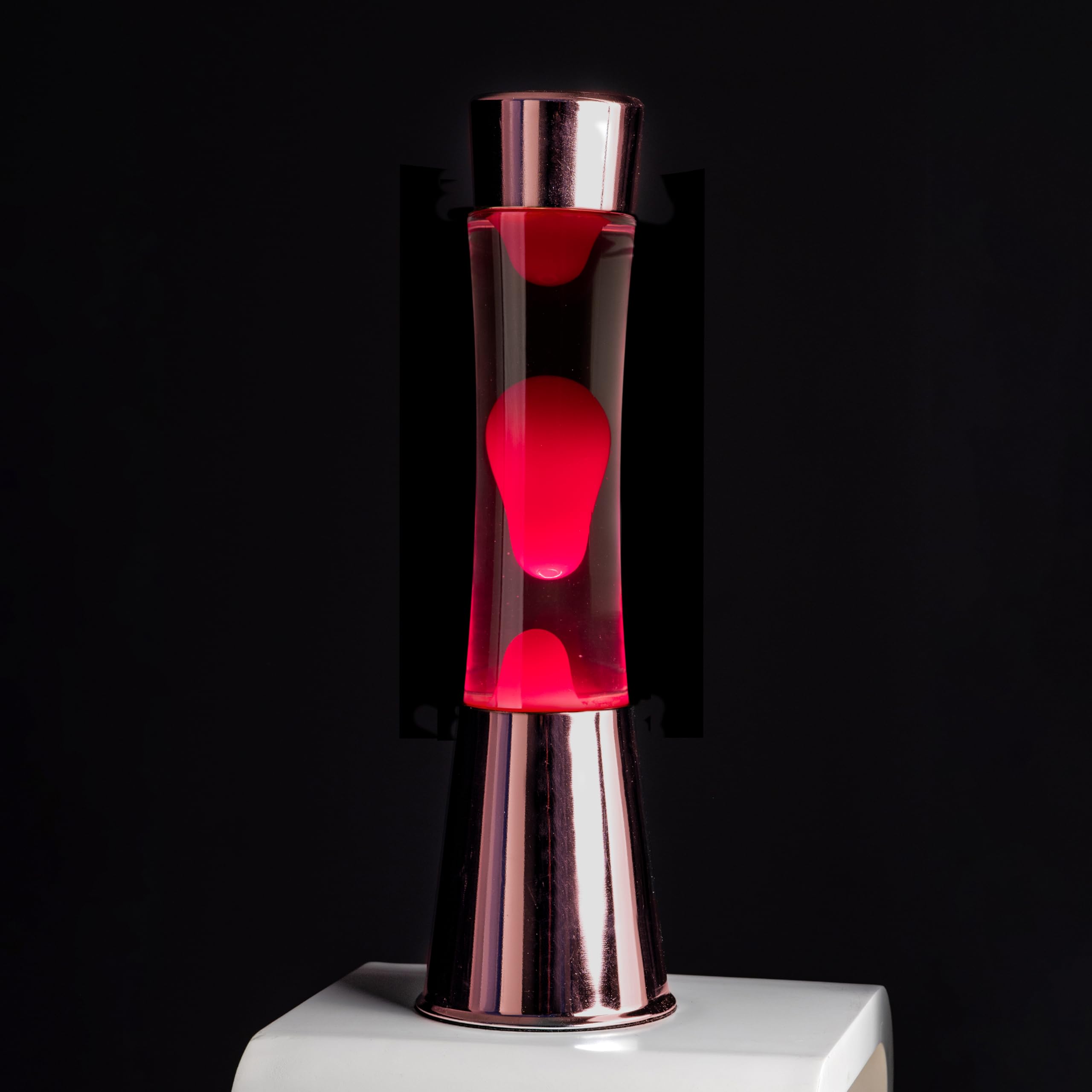 Fisura - Lámpara de lava rosa. Base cromada oro rosa, líquido transparente y lava. Lámpara efecto relajante. Con bombilla de repuesto. 11 cm x 11cm x 39,5 cm