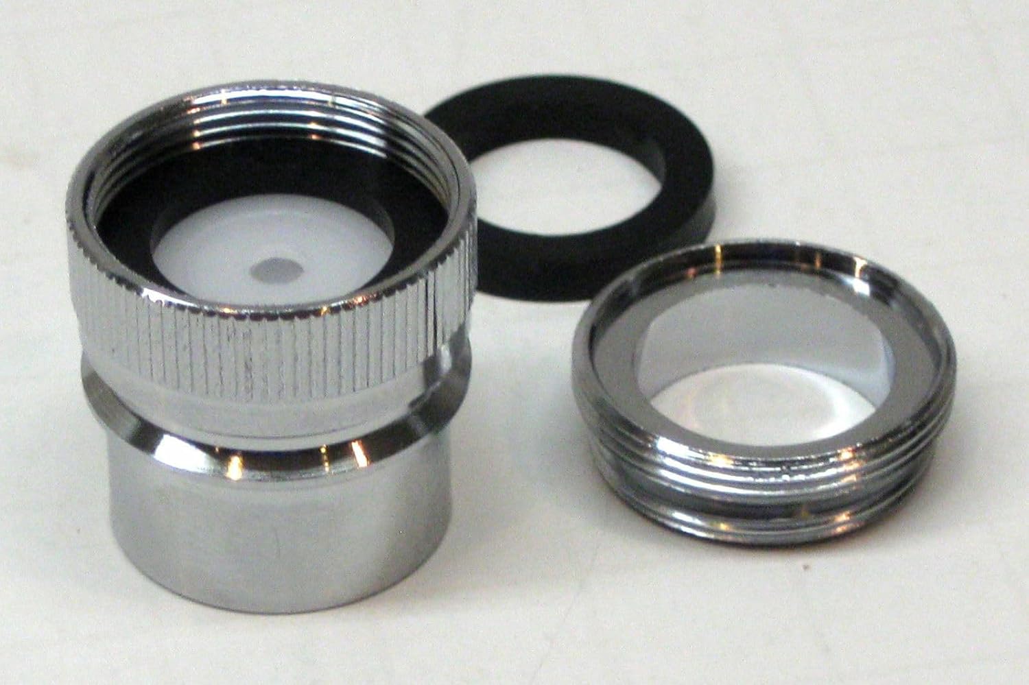 Close-up of the dishwasher faucet adapter showing internal threads and washer