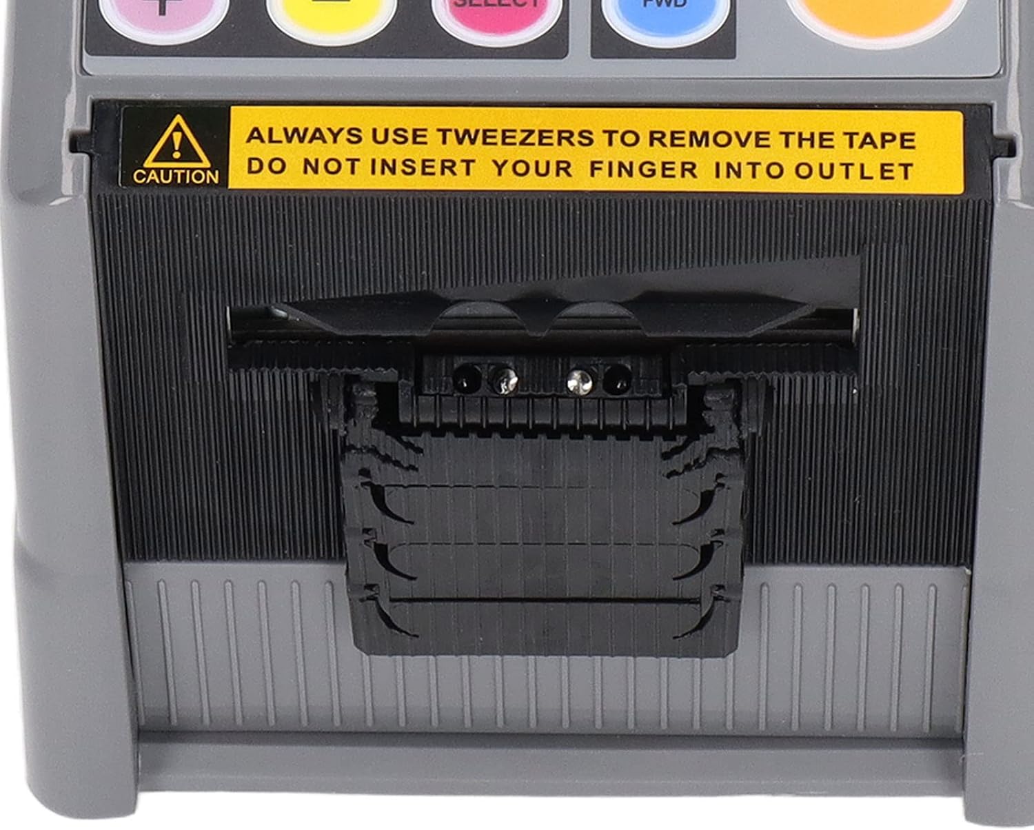 Close-up of the tape outlet with a caution label