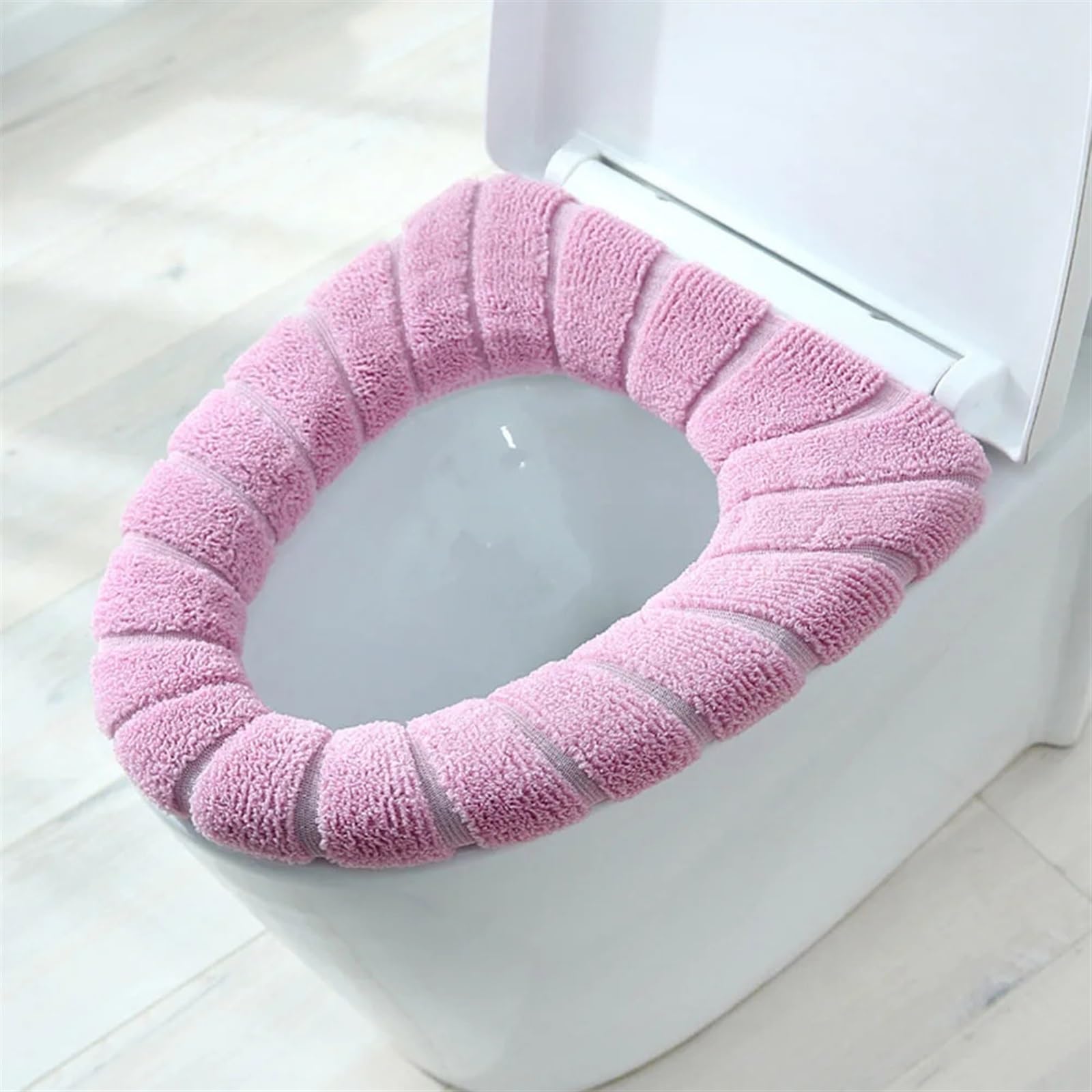 Tapis de cuvette de toilette rose pour éliminer le contact froid