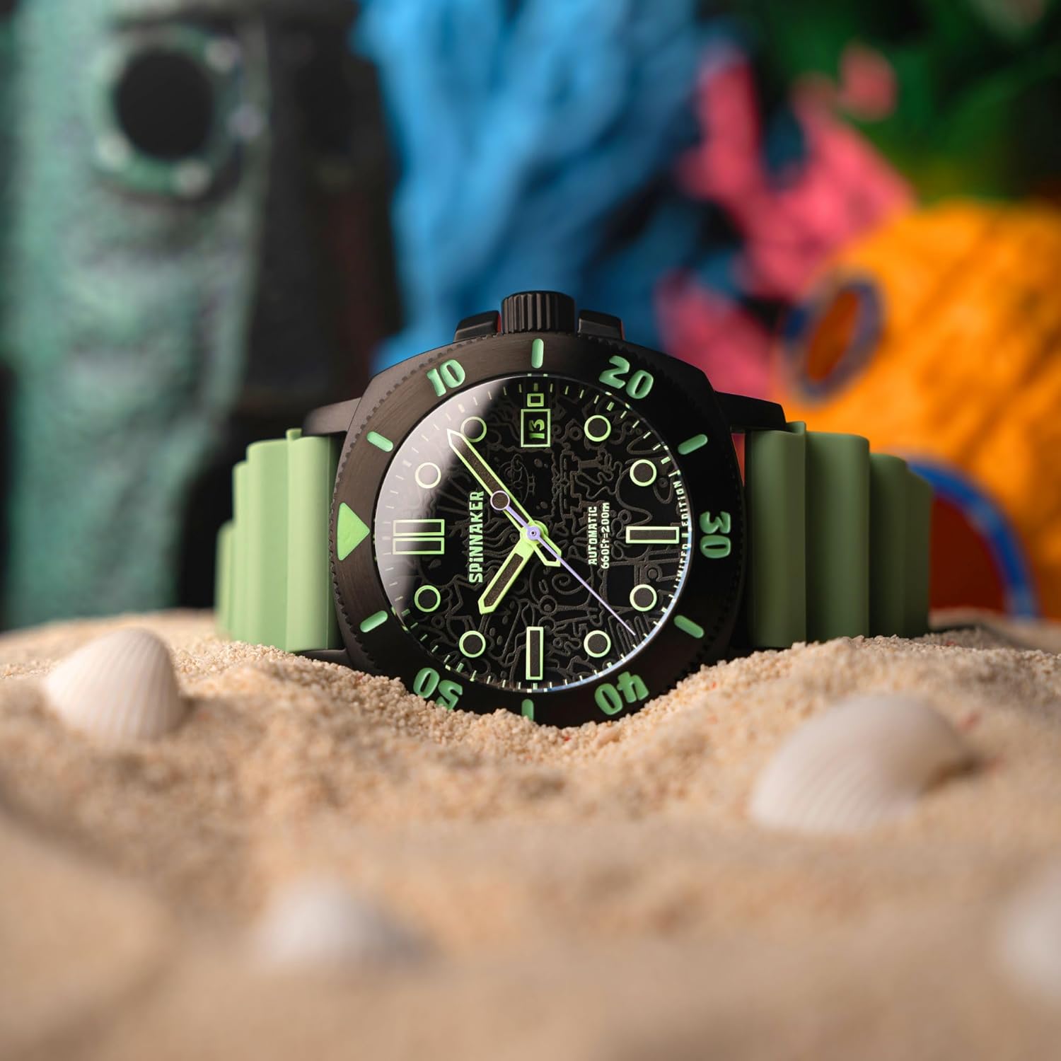 Spinnaker Hull Diver watch on sand, showing the bezel