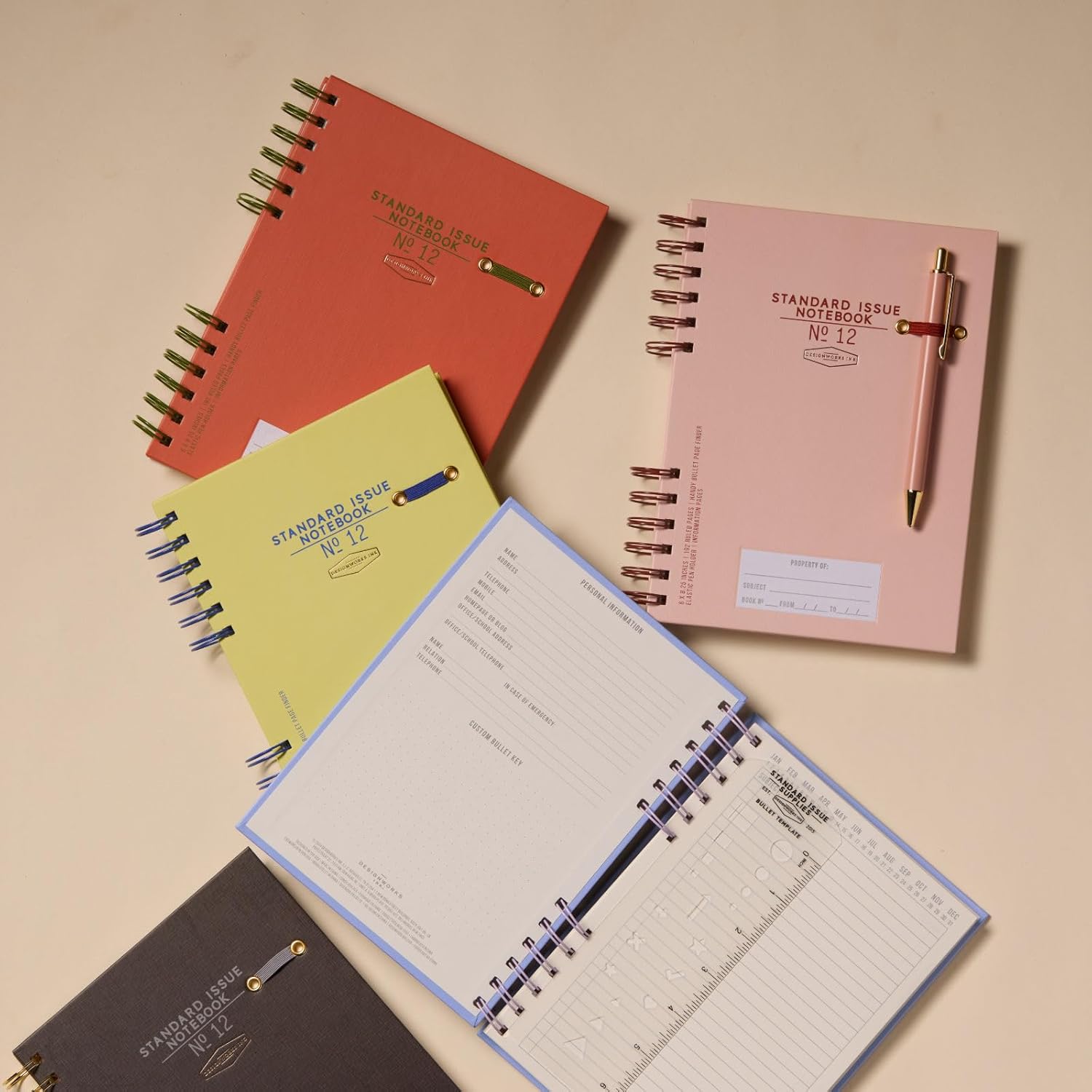 DesignWorks Ink Standard Issue Notebook No. 12, Undated Daily Planner & Writing Journal, 192 Lined Pages, Elastic Pen Holder, Small Spiral Notebook for Work & Journaling, 6 x 8.25 in, Lavender/Periwinkle