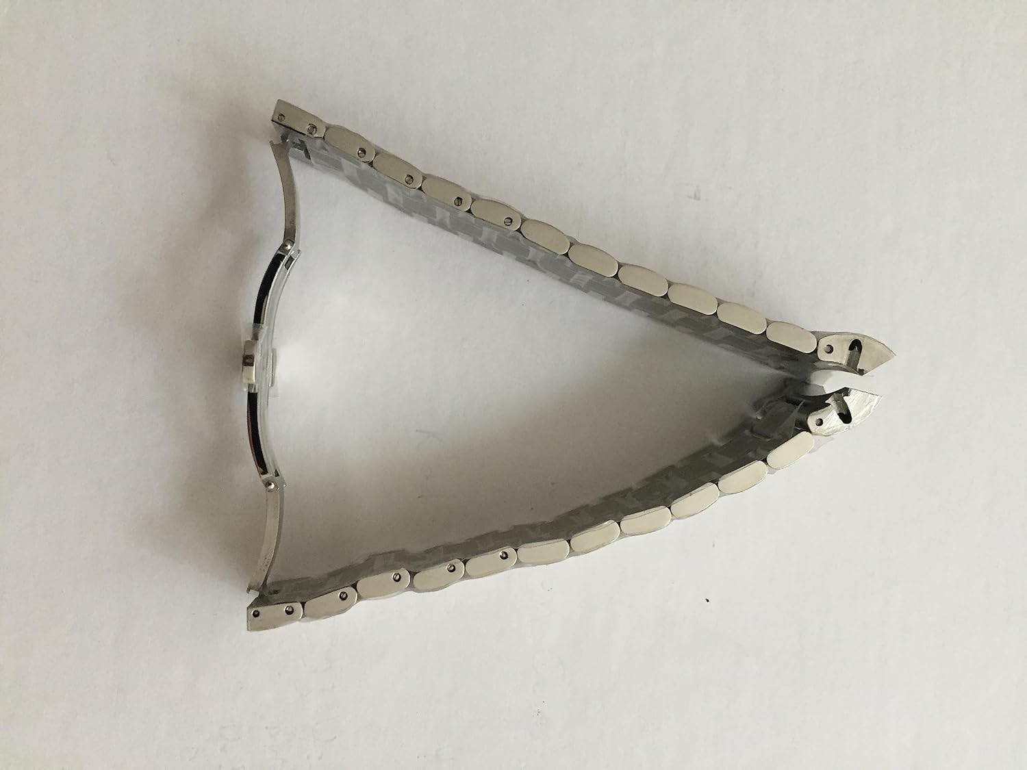 O brățară de ceas din oțel argintiu, pliată în formă de V, care arată partea interioară a zalelor și conexiunile cu știft.