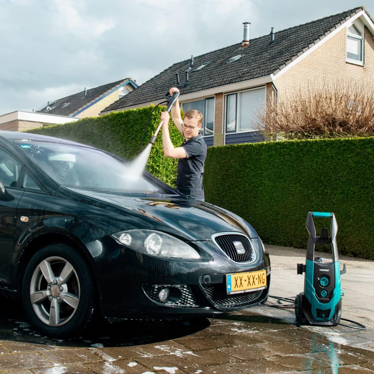 Person cleaning a car with VONROC pressure washer