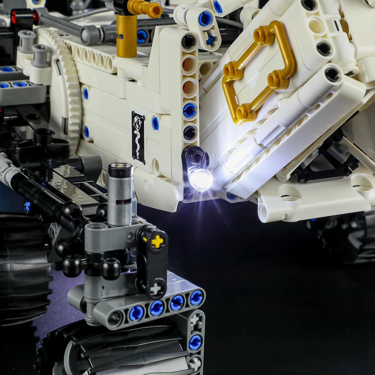 The BRIKSMAX LED lighting kit box opened, displaying the instruction manual, service card, and various lighting components neatly arranged.