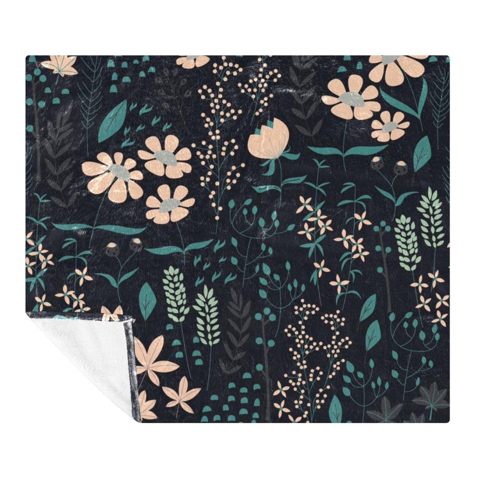 Couverture polaire fleurs 150x130 pour adulte et enfant sur canapé