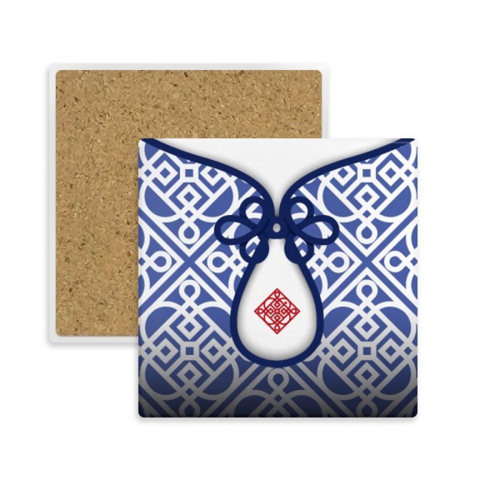 Tasse bleue de fleur et dessous de verre carré en pierre absorbante