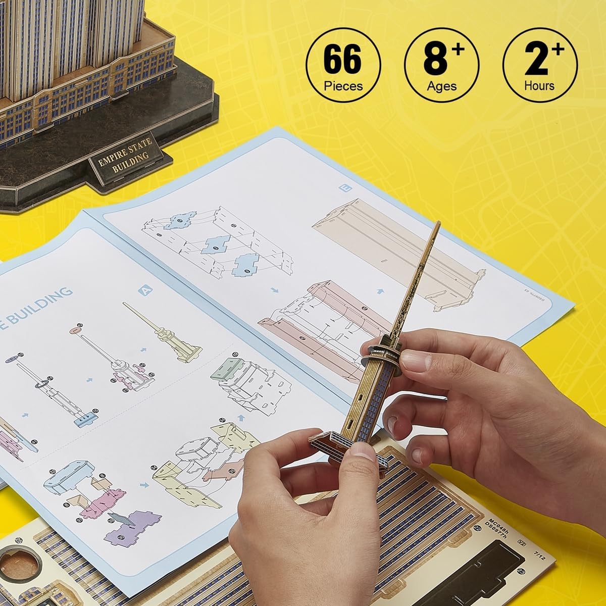 Hands assembling a piece of the CubicFun Empire State Building 3D puzzle