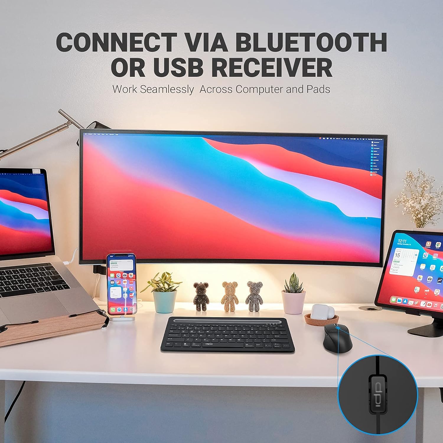 A desk setup with a laptop, monitor, smartphone, and tablet, all connected to a Rapoo keyboard and the MT550 mouse, illustrating multi-device connectivity via Bluetooth or USB receiver.