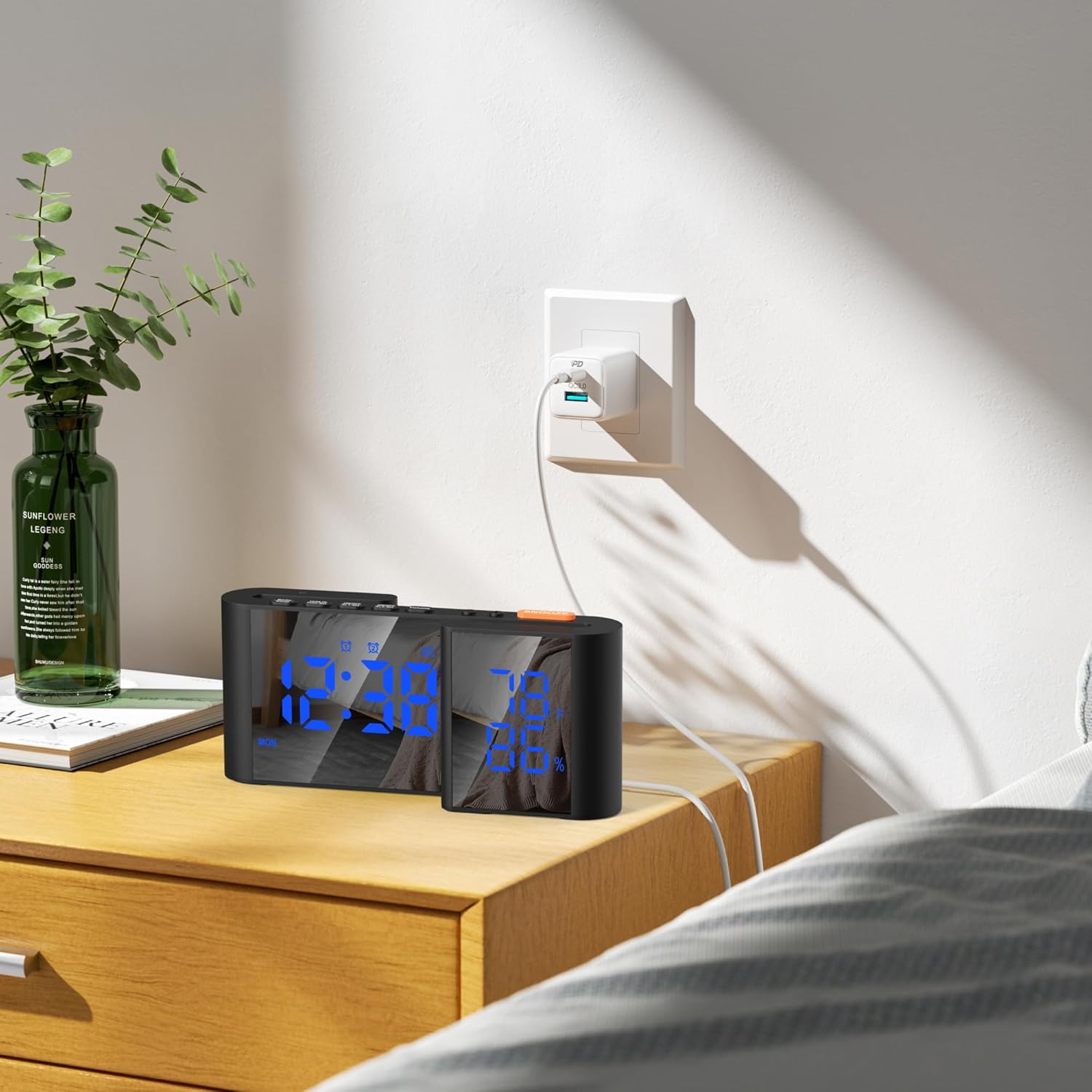 Alarm clock connected to power outlet on a bedside table